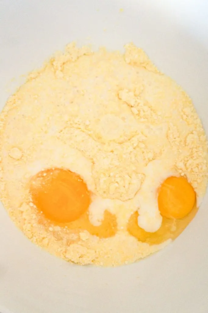 milk, eggs and jiffy mix in a mixing bowl