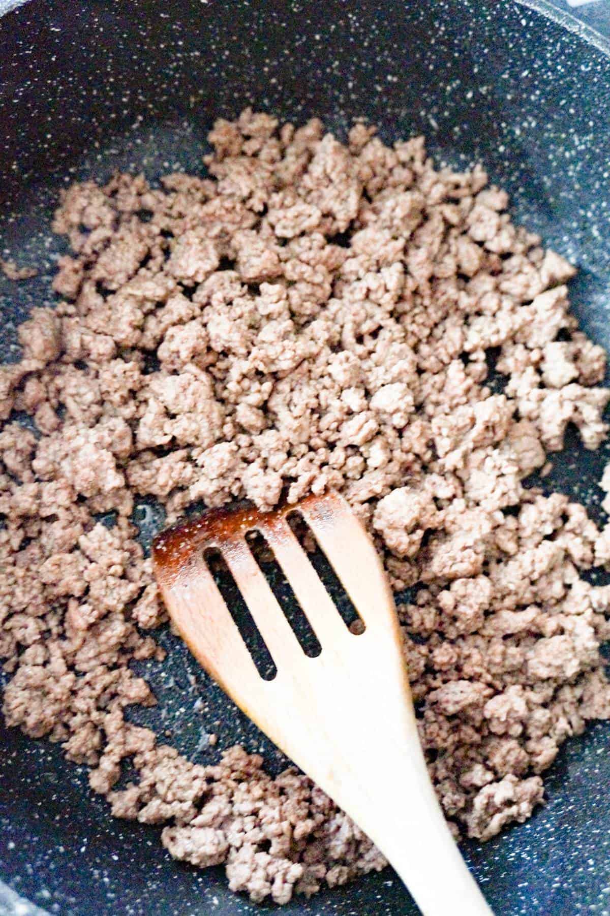 cooked ground beef in a saute pan