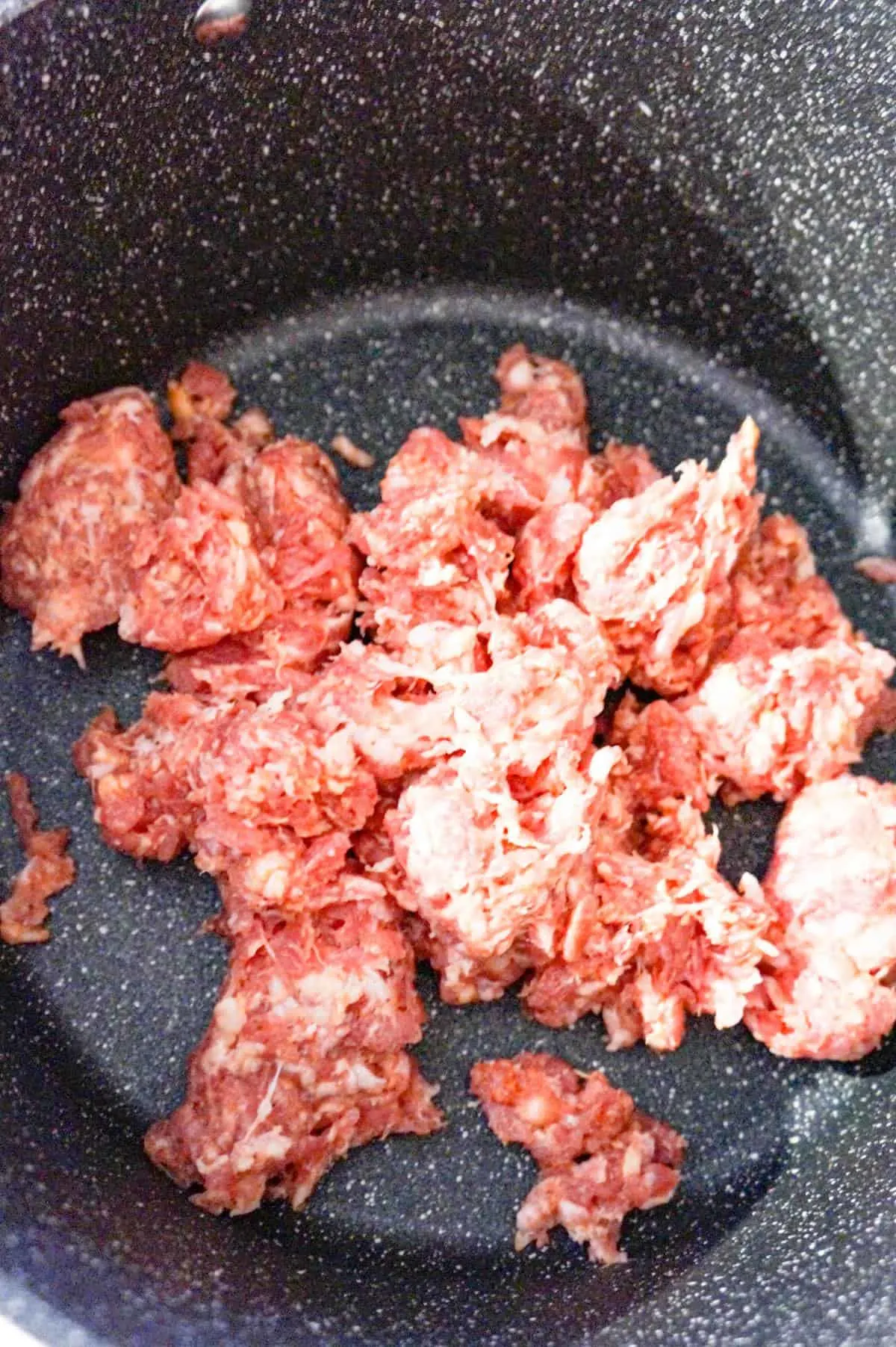 raw Italian sausage meat in a large pot