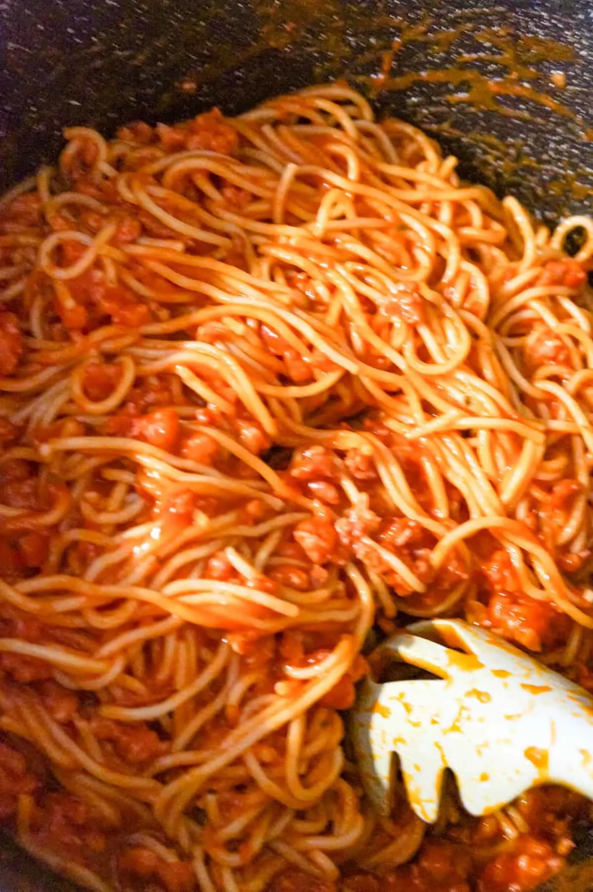 marinara, ground sausage and spaghetti in a large pot