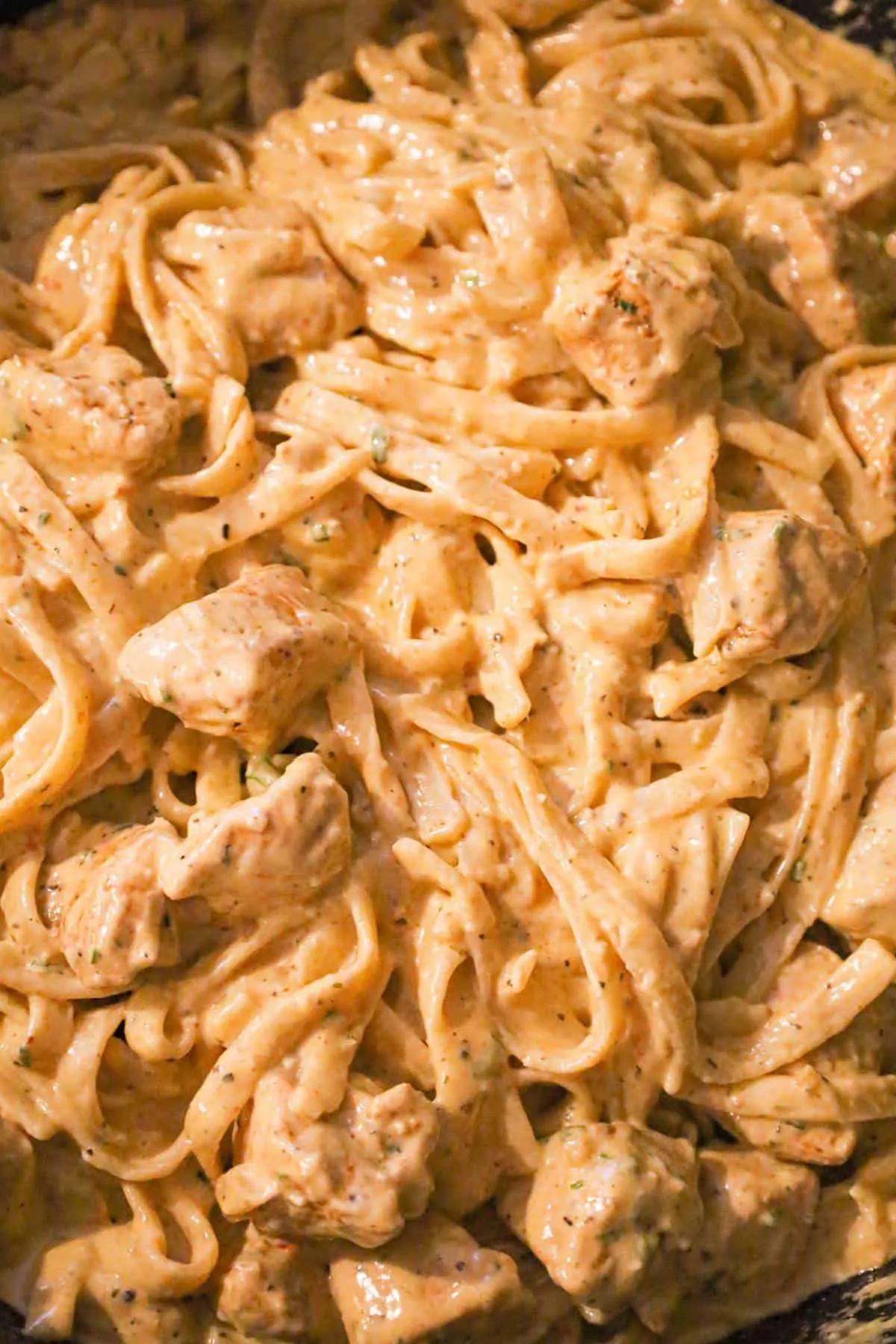 cajun chicken fettuccine alfredo in a saute pan