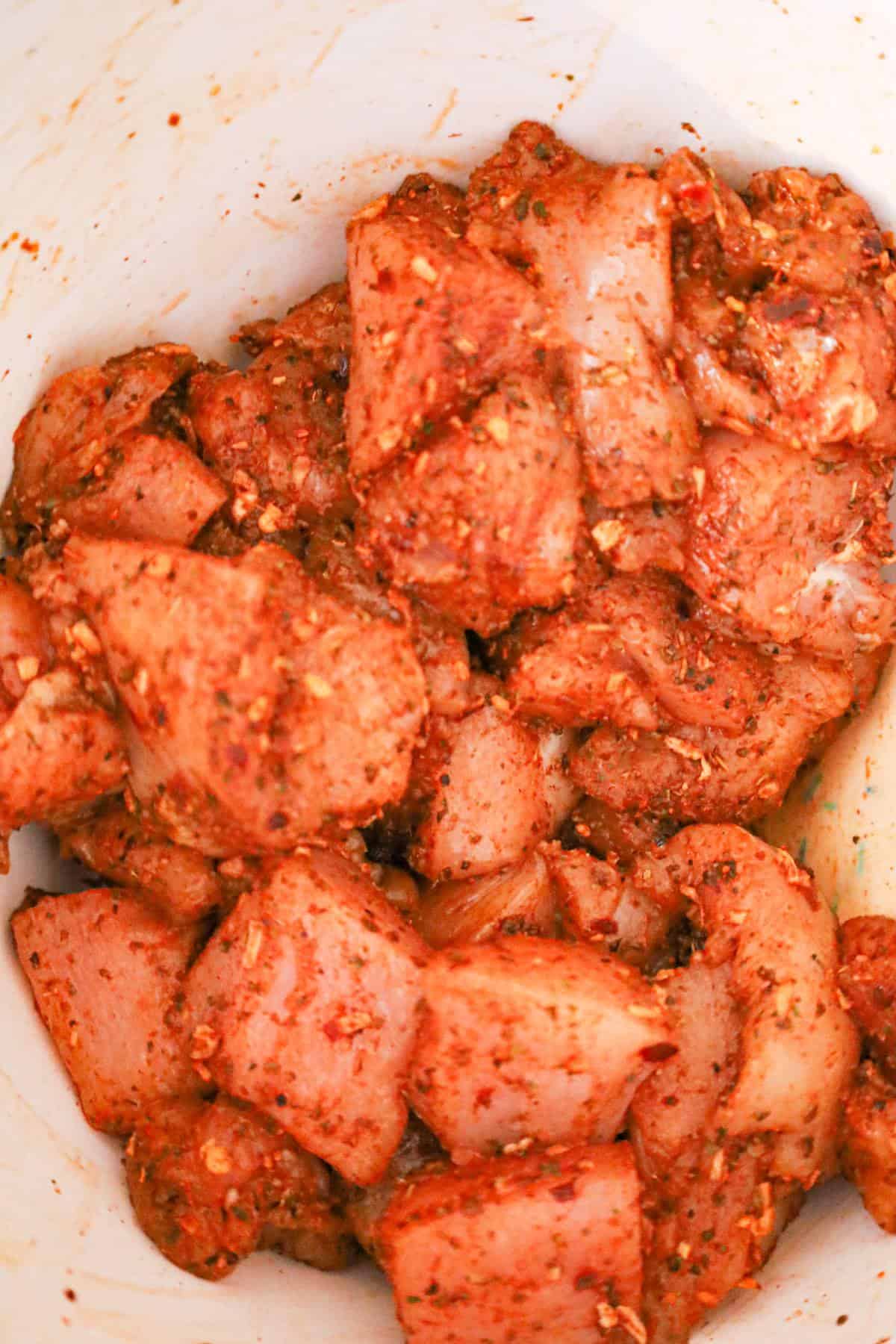 chicken chunks coated in cajun seasoning in a mixing bowl