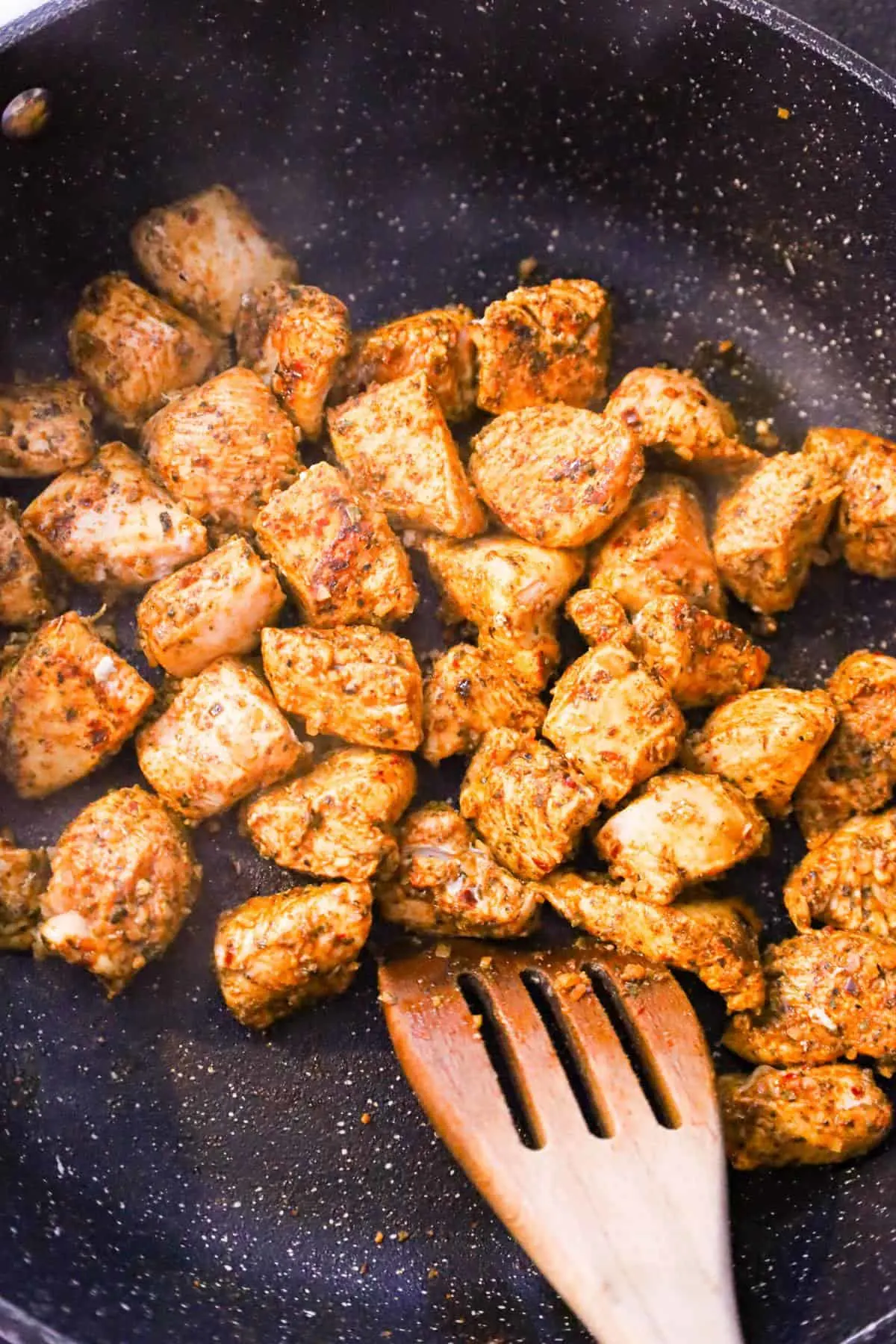cajun chicken chunks cooking in a saute pan