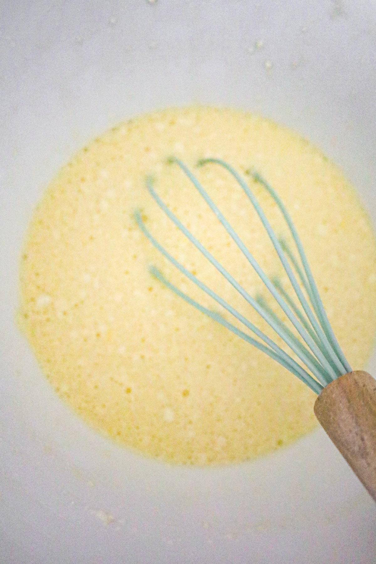 bisquick batter being whisked in a mixing bowl