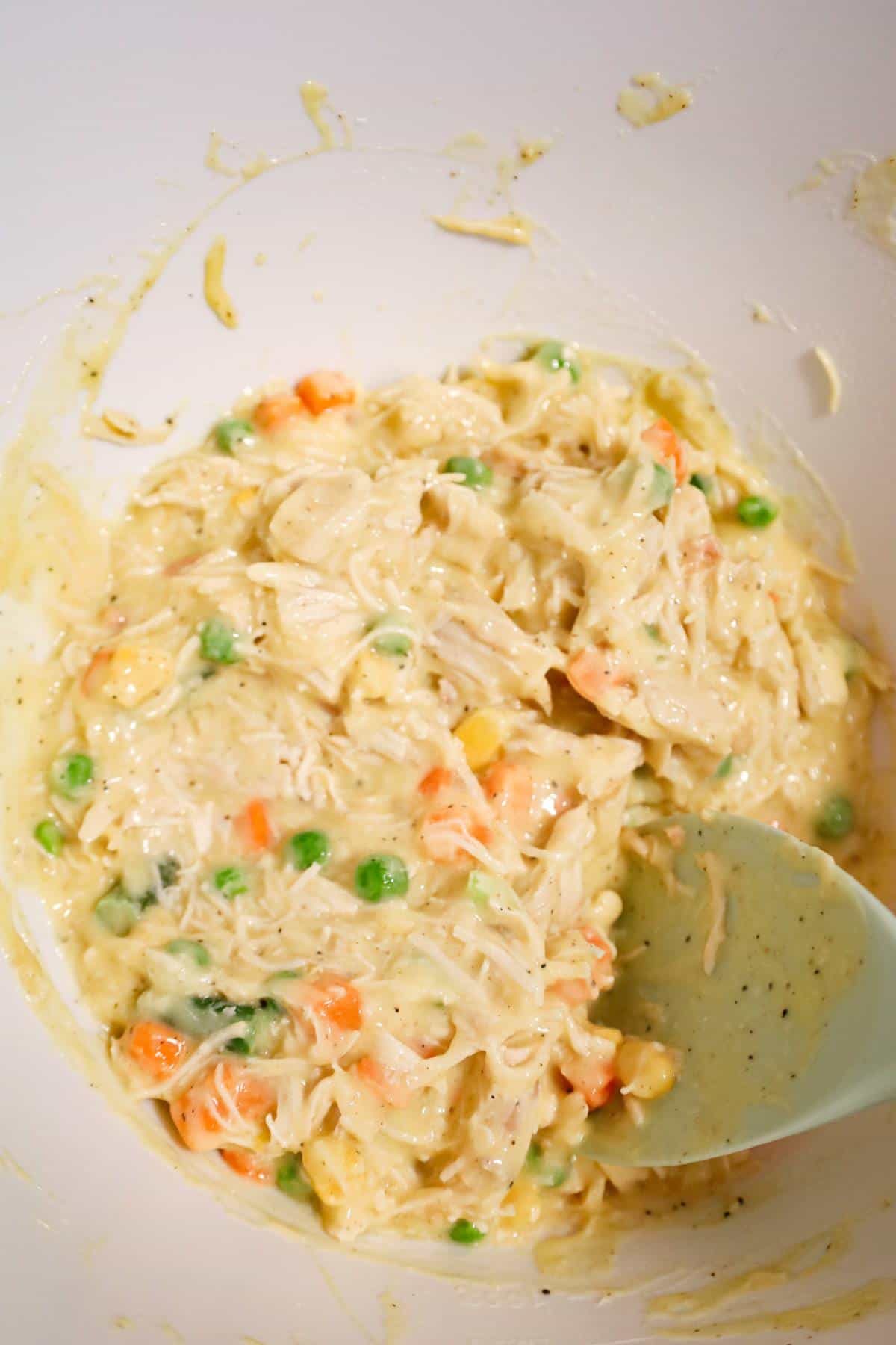 creamy chicken and vegetable mixture in a mixing bowl