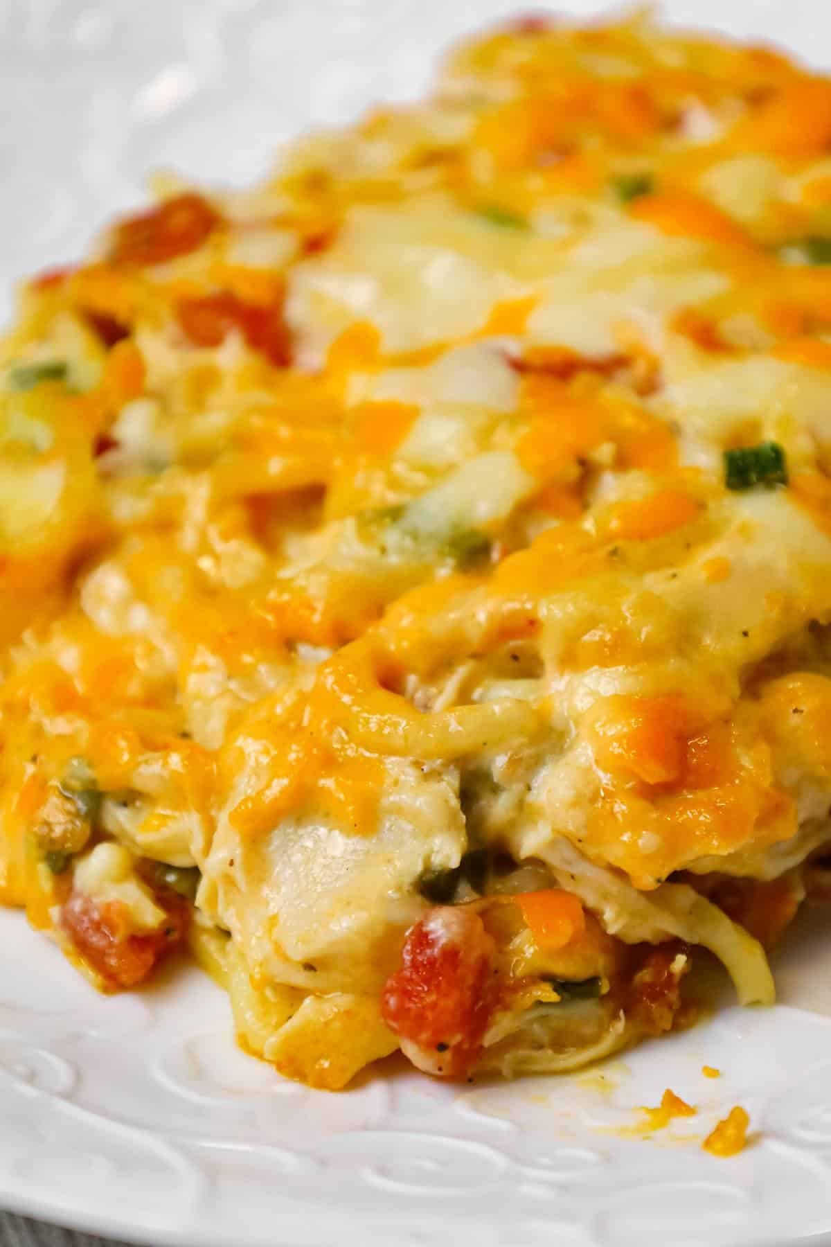 Chicken Spaghetti with Rotel is a delicious baked spaghetti recipe with a creamy sauce loaded with shredded chicken, Rotel diced tomatoes and green chilies, shredded cheese and chopped green onions.