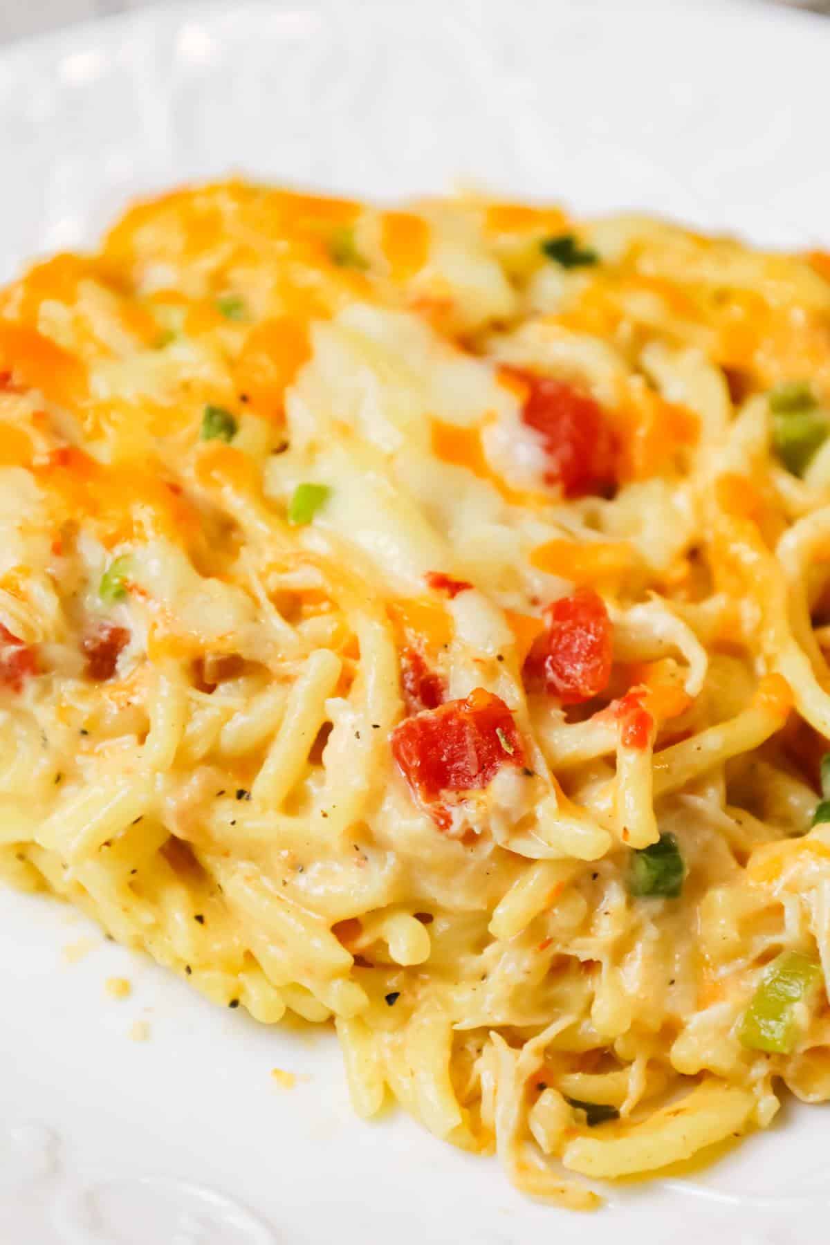 Chicken Spaghetti with Rotel is a delicious baked spaghetti recipe with a creamy sauce loaded with shredded chicken, Rotel diced tomatoes and green chilies, shredded cheese and chopped green onions.