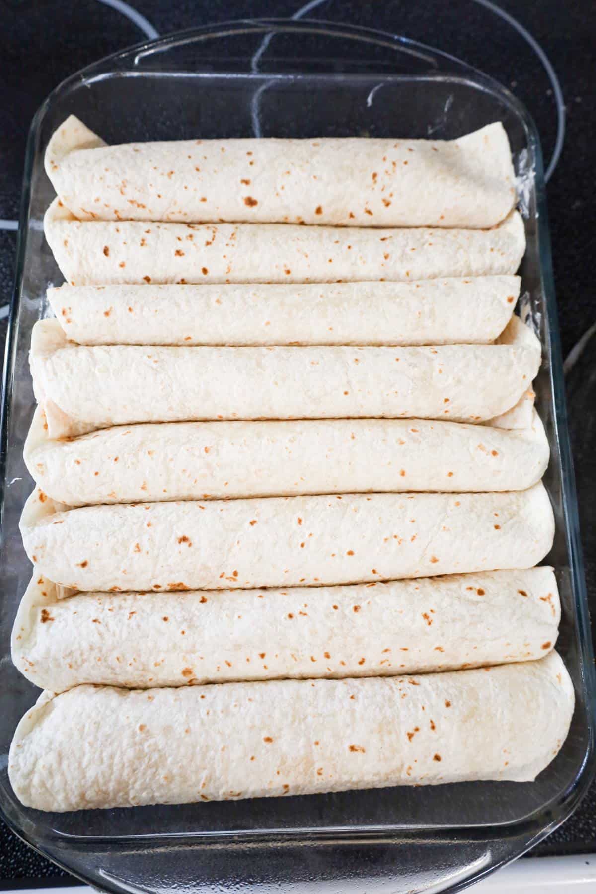 rolled up tortillas in a baking dish
