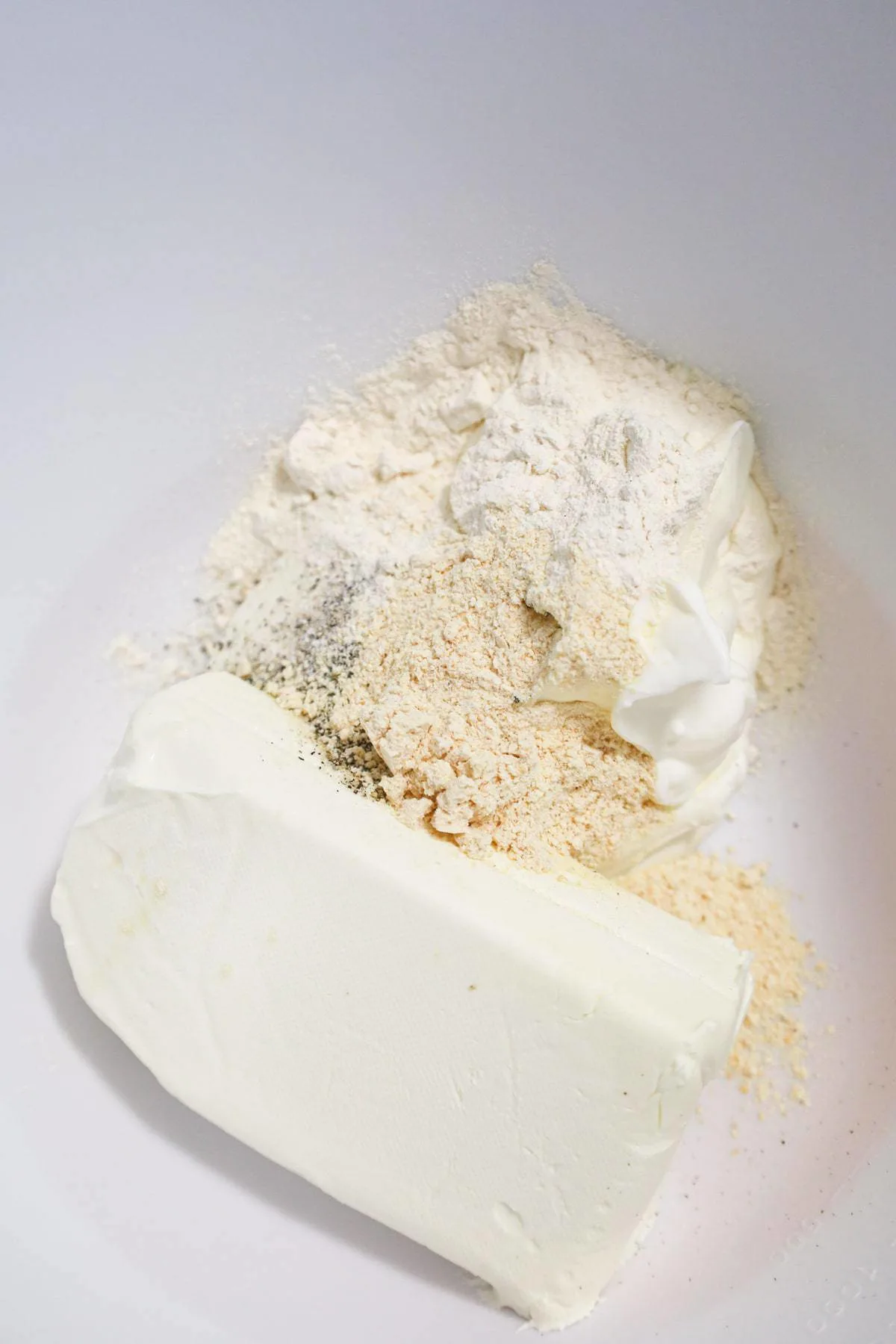 spices, sour cream and cream cheese in a mixing bowl