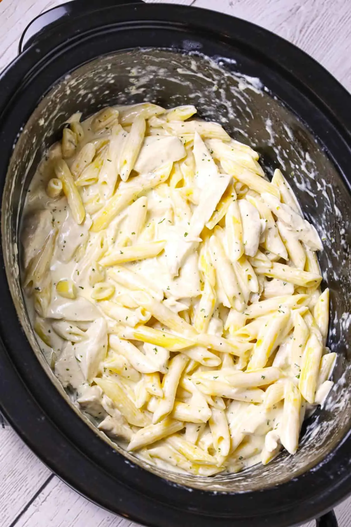 Crock Pot Chicken Alfredo is a delicious slow cooker penne pasta recipe loaded with chunks boneless, skinless chicken breasts and all tossed in a creamy garlic and parmesan sauce.