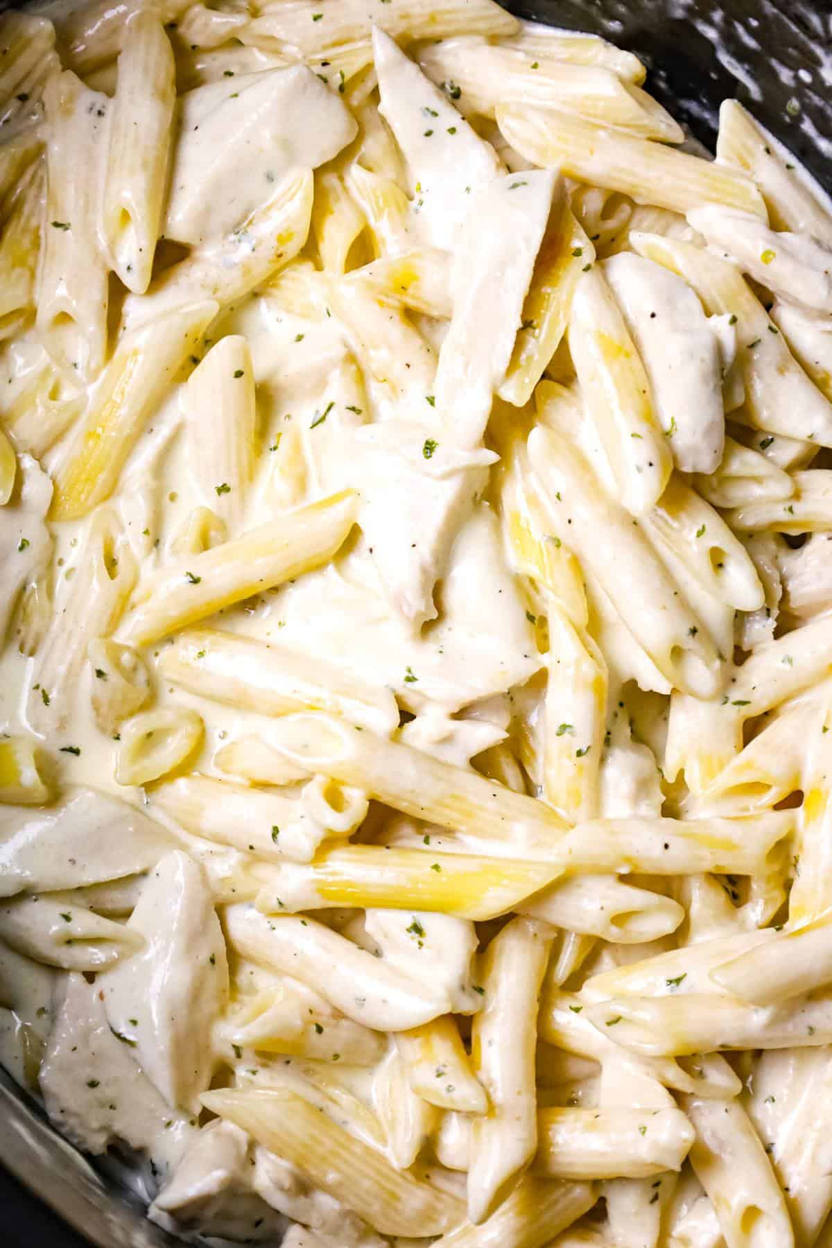 Crock Pot Chicken Alfredo is a delicious slow cooker penne pasta recipe loaded with chunks boneless, skinless chicken breasts and all tossed in a creamy garlic and parmesan sauce.