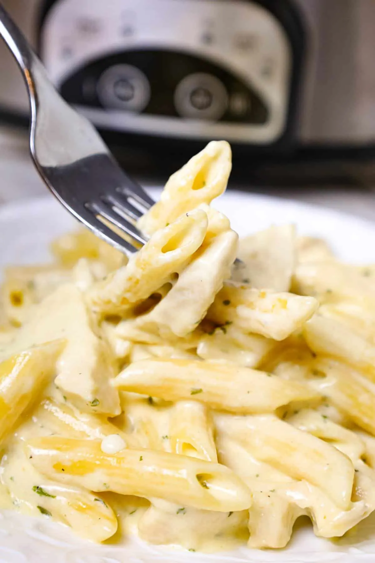 Crock Pot Chicken Alfredo is a delicious slow cooker penne pasta recipe loaded with chunks boneless, skinless chicken breasts and all tossed in a creamy garlic and parmesan sauce.