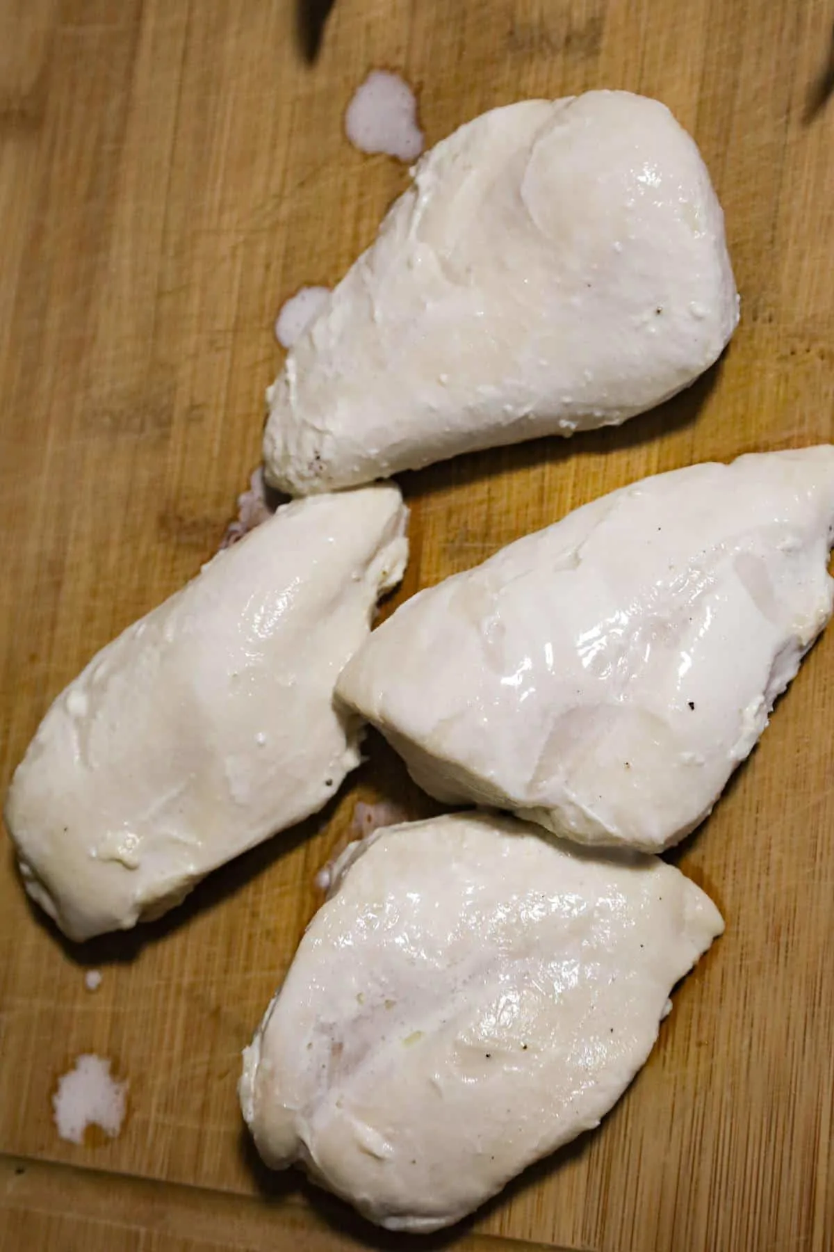 cooked chicken breasts on a cutting board