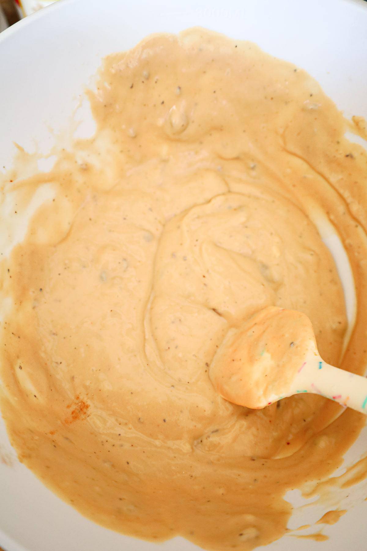 cream of mushroom soup and gravy mixture in a mixing bowl