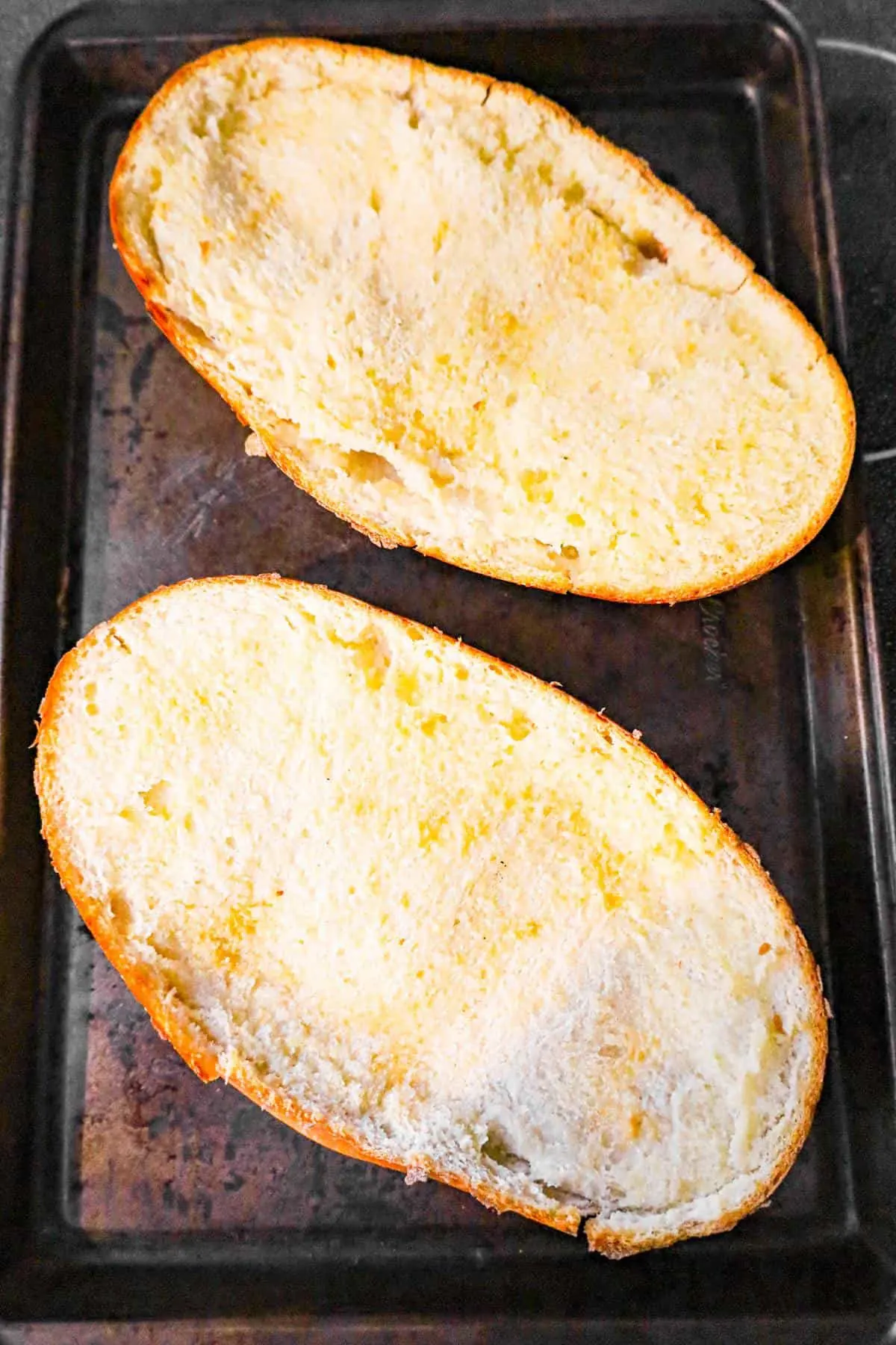 garlic toasted French bread on a baking sheet