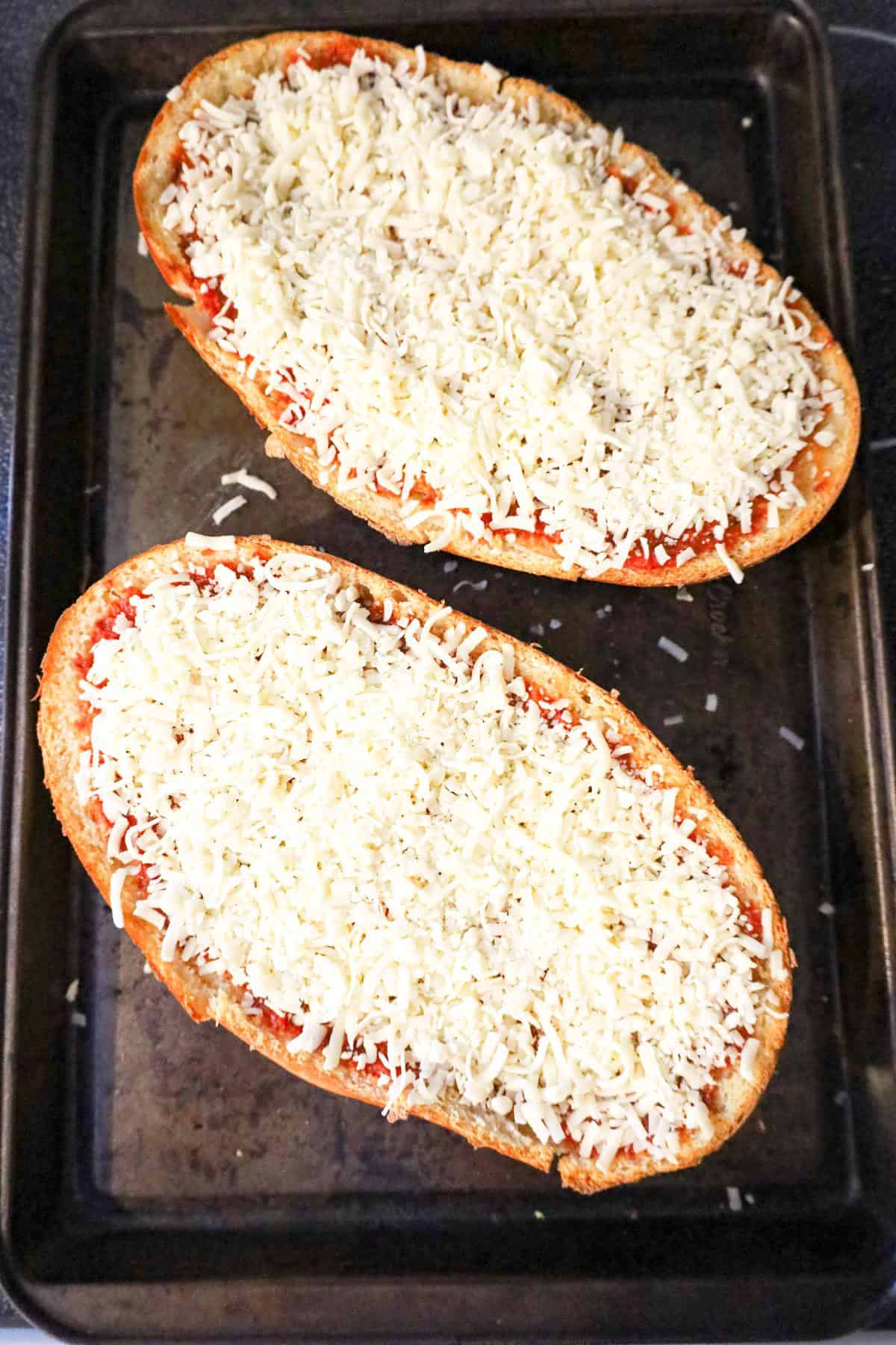 shredded mozzarella and pizza sauce on top of French bread