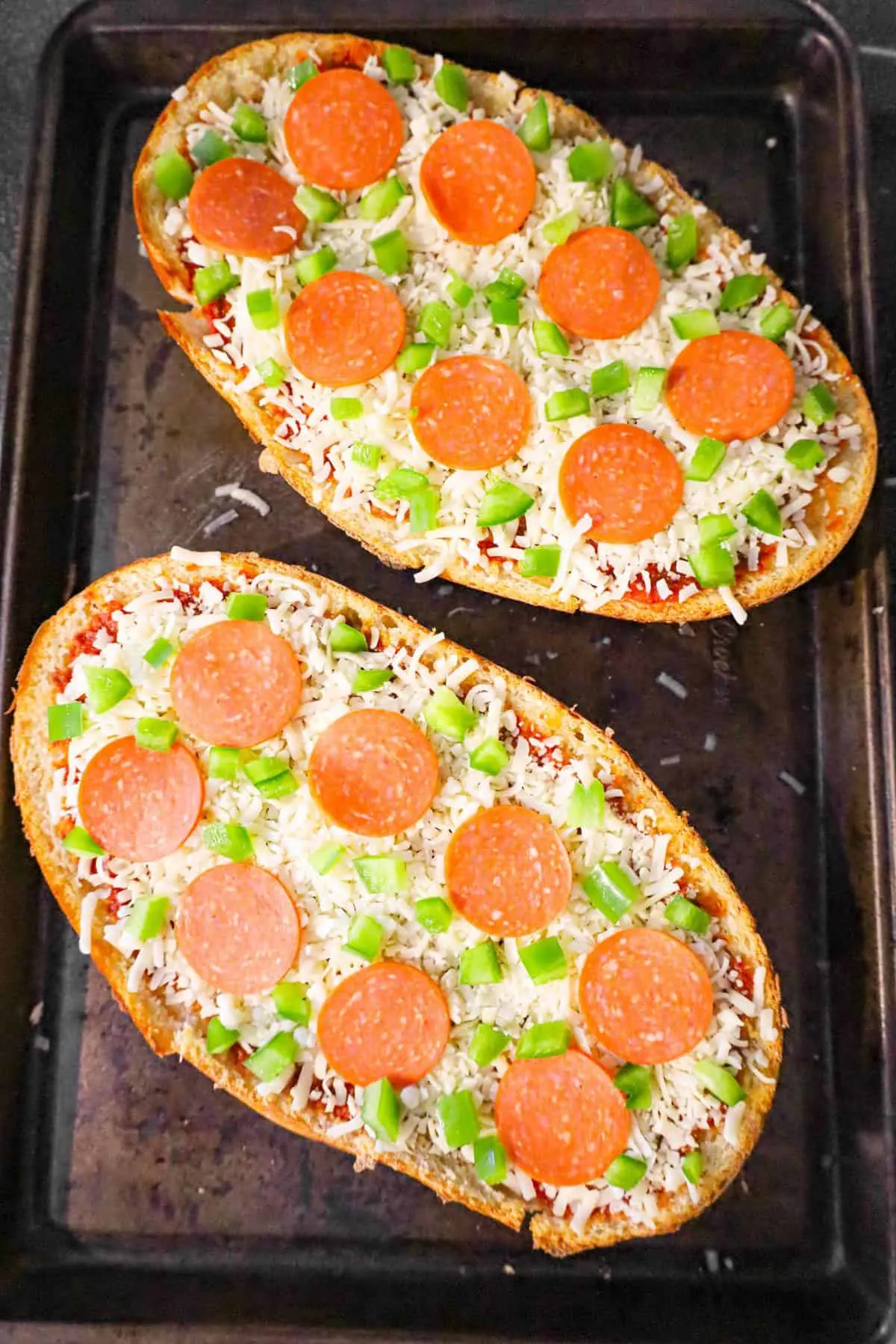 pepperoni, diced green peppers and shredded mozzarella cheese on top of french bread