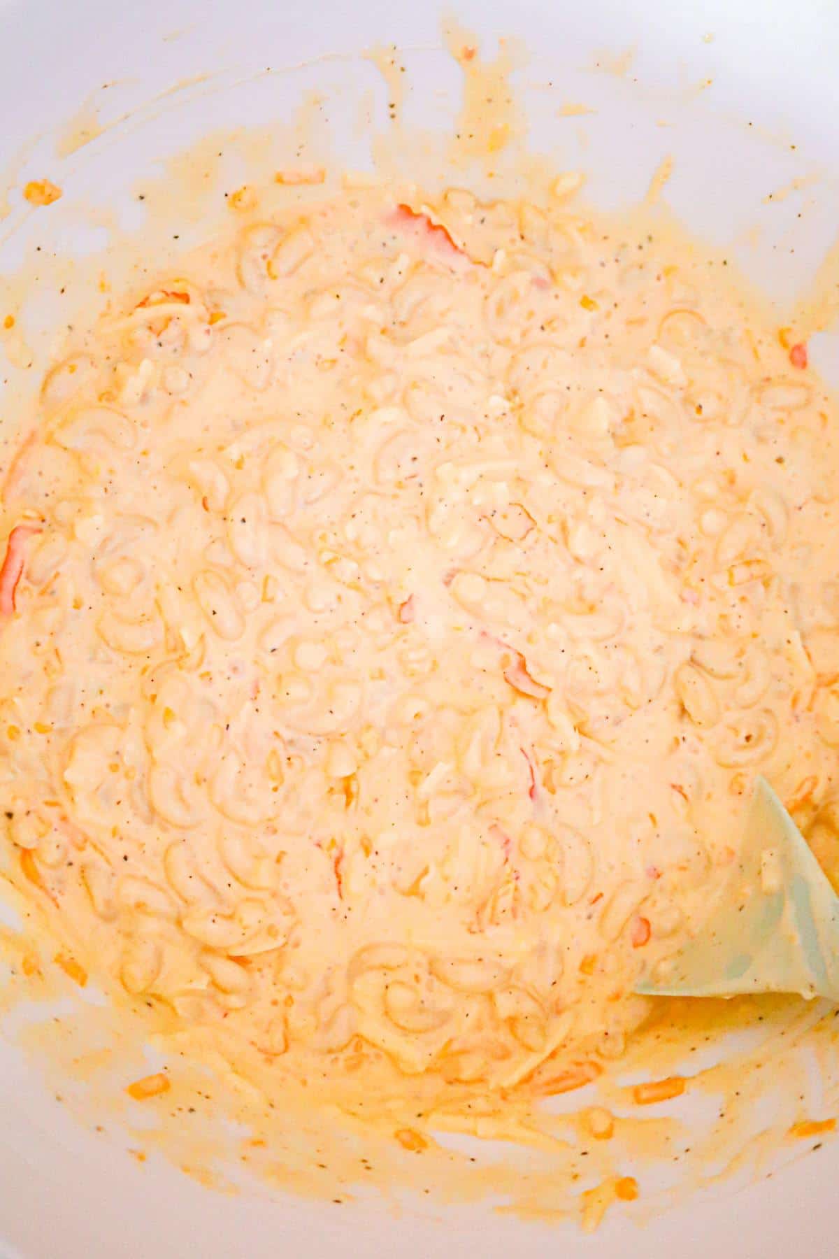 creamy macaroni and cheese mixture in a mixing bowl