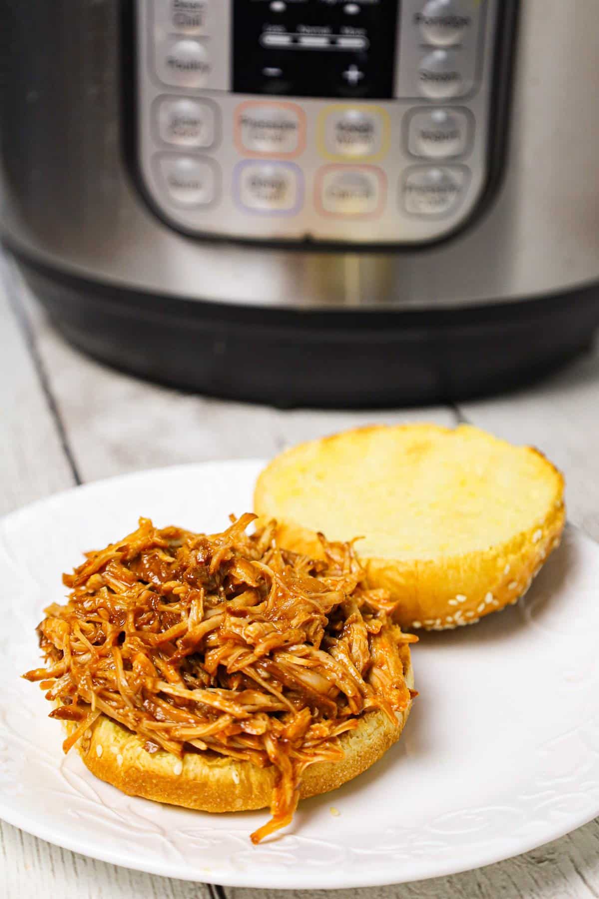 Instant Pot Pulled Pork is an easy and delicious dinner made with a boneless pork roast pressure cooked in apple juice and BBQ sauce.