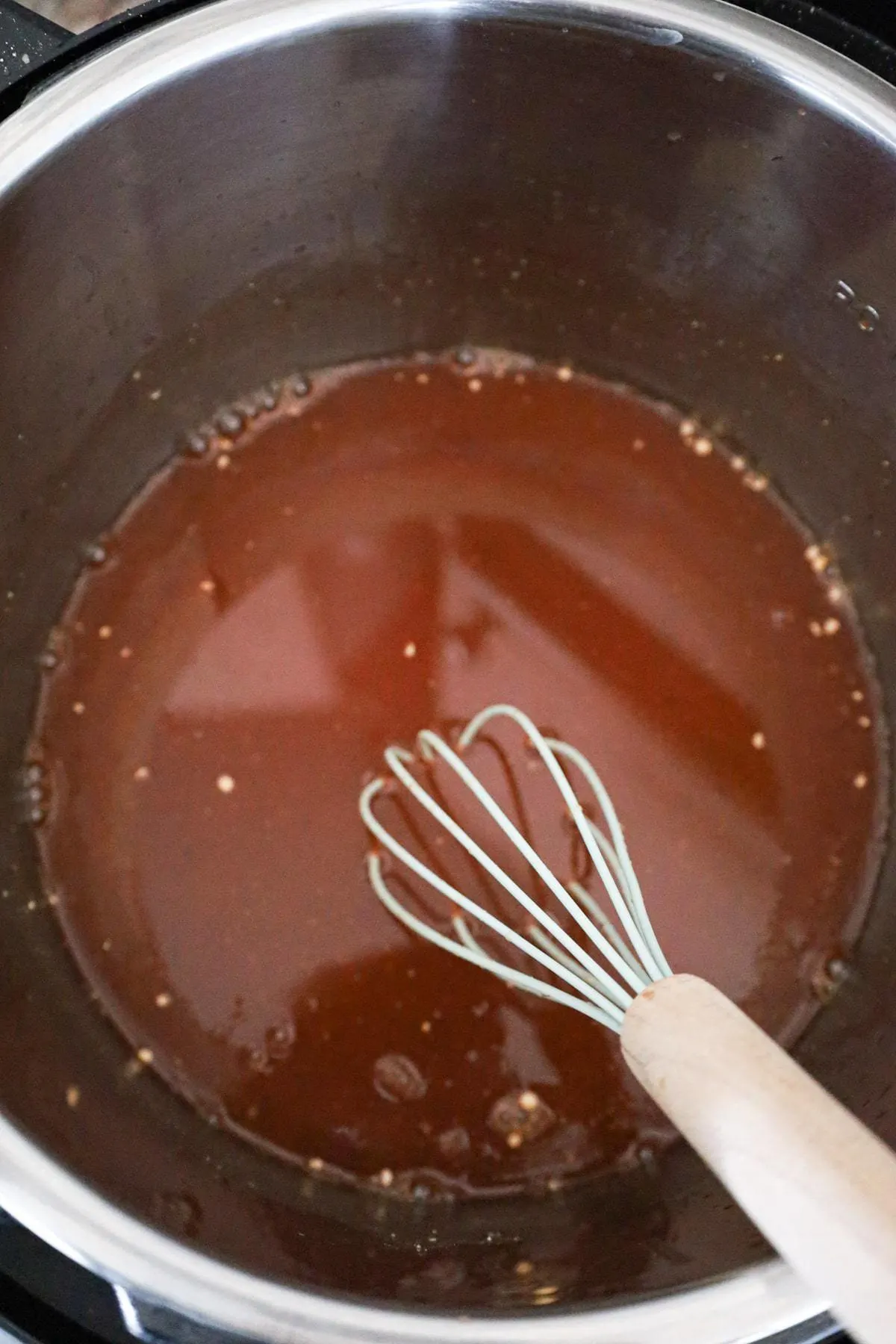 barbecue sauce, apple juice and chicken broth mixture in an Instant Pot