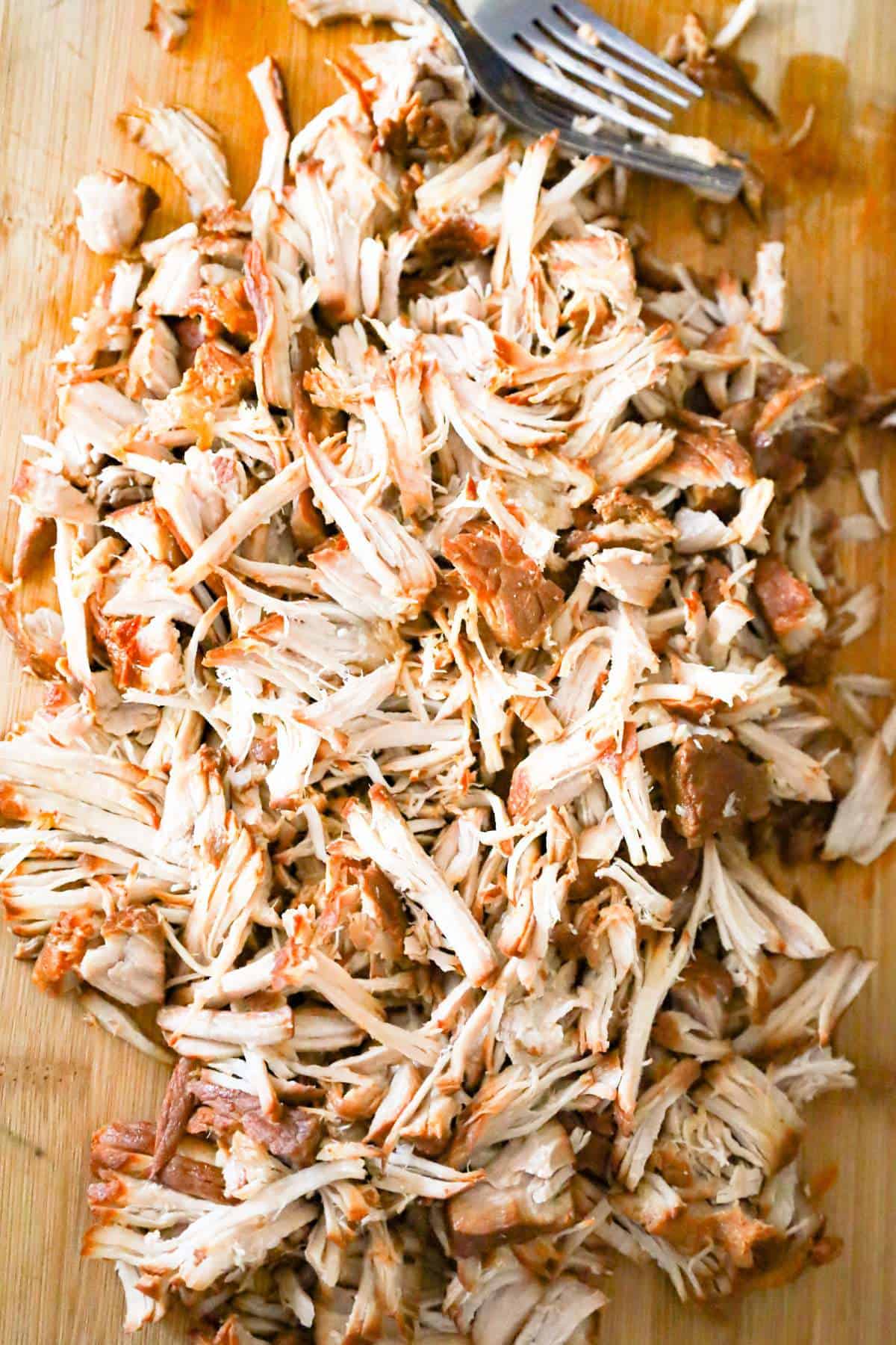 shredded pork on a cutting board