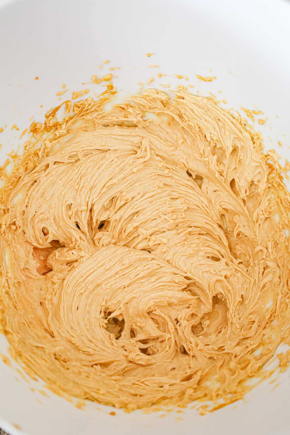 creamy peanut butter and butter mixture in a mixing bowl