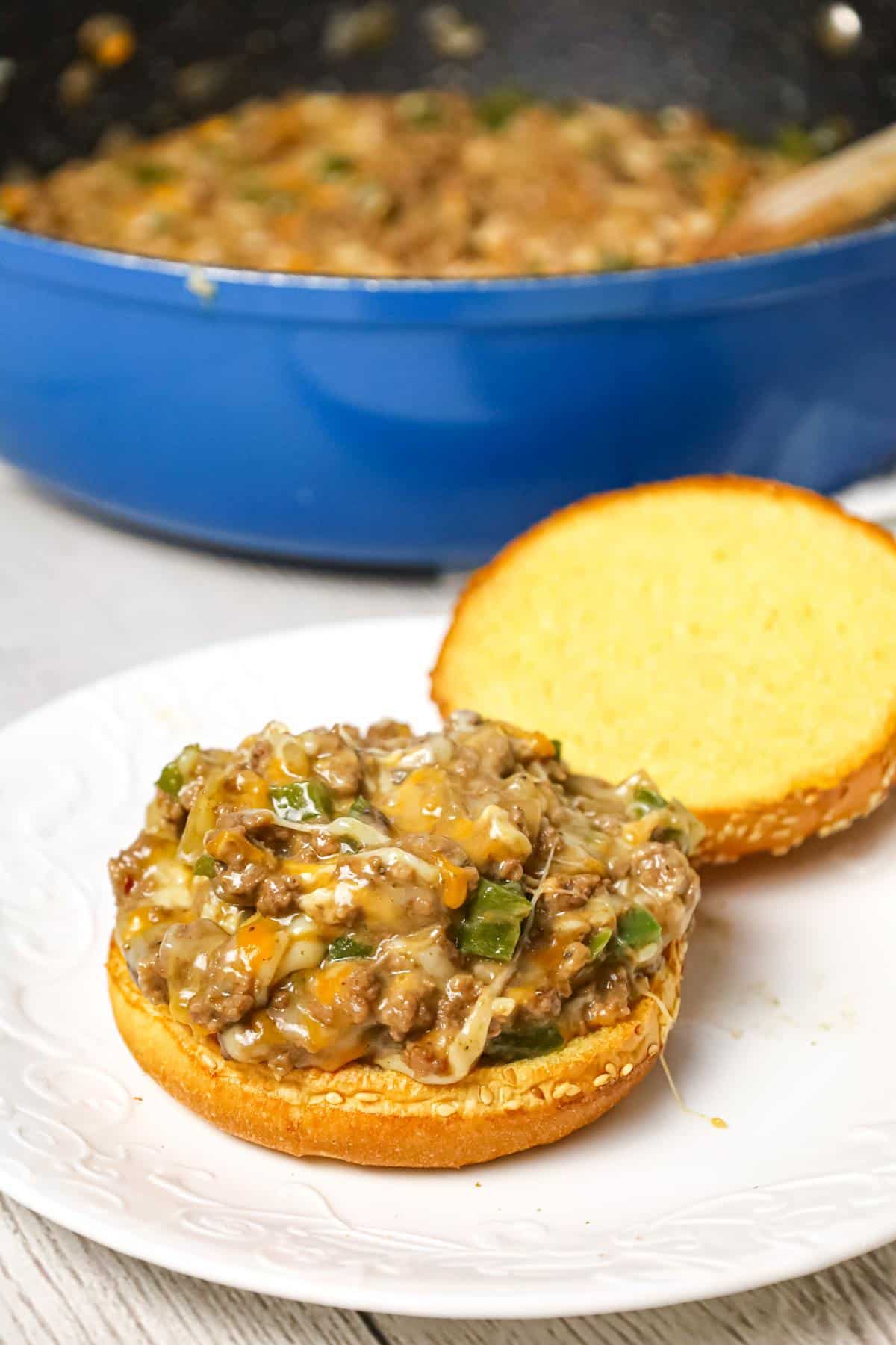 Philly Cheese Steak Sloppy Joes are an weeknight dinner recipe using ground beef loaded with green peppers, onions and shredded cheese all served on toasted Brioche buns.