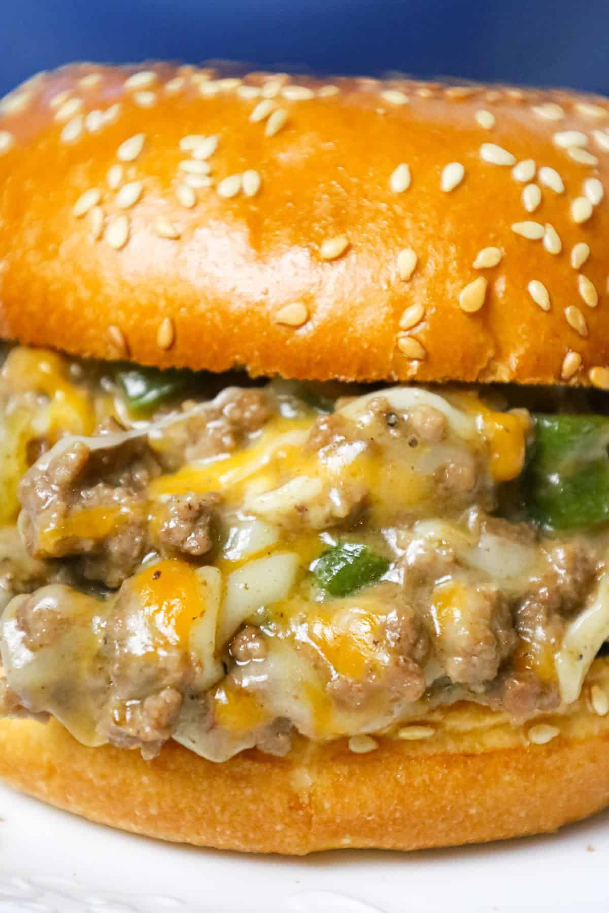 Philly Cheese Steak Sloppy Joes are an weeknight dinner recipe using ground beef loaded with green peppers, onions and shredded cheese all served on toasted Brioche buns.