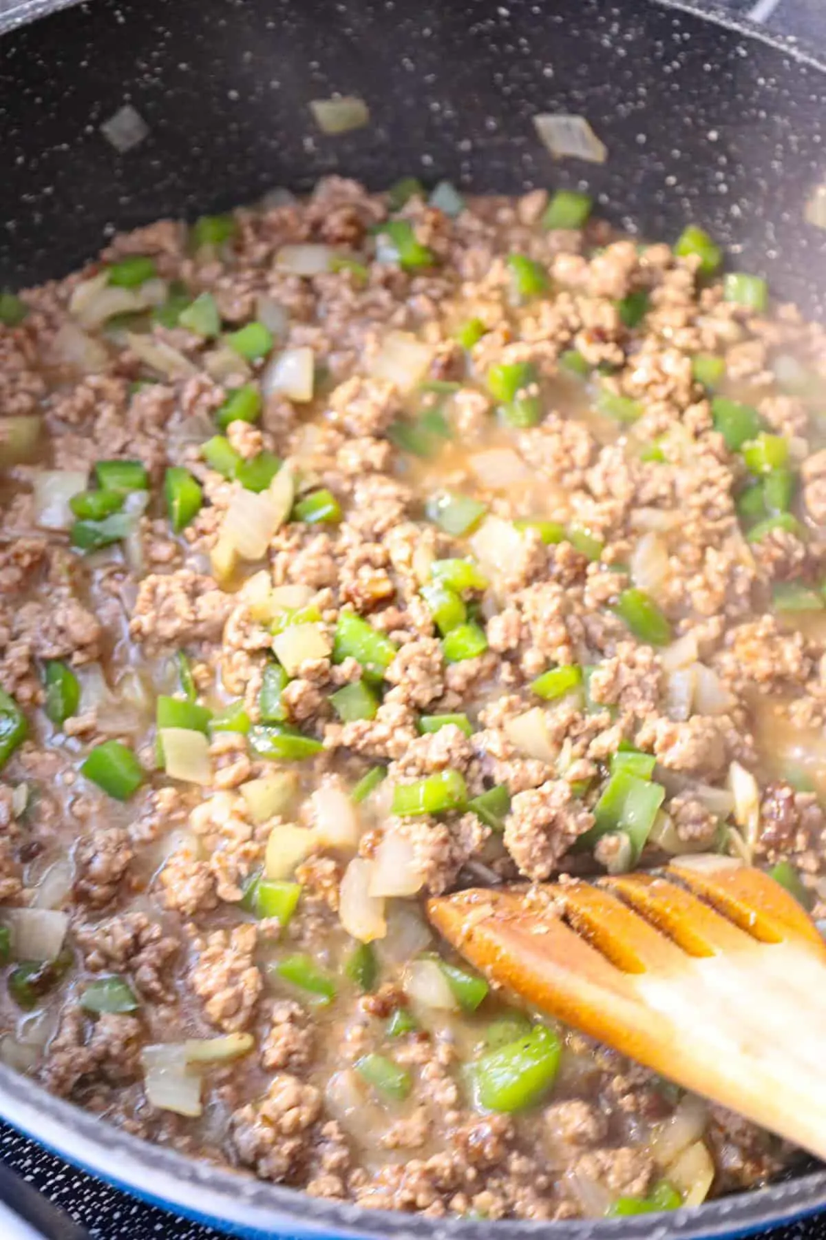 cooked ground beef and diced green peppers in gravy mixture