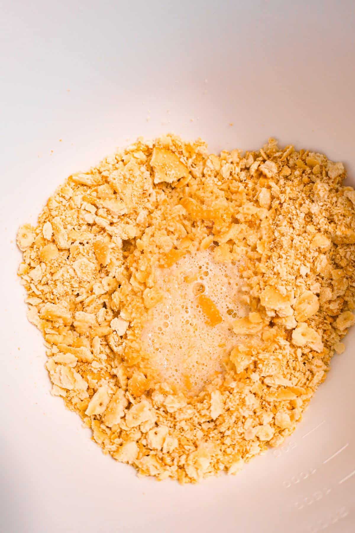melted butter and Ritz cracker crumbs in a mixing bowl
