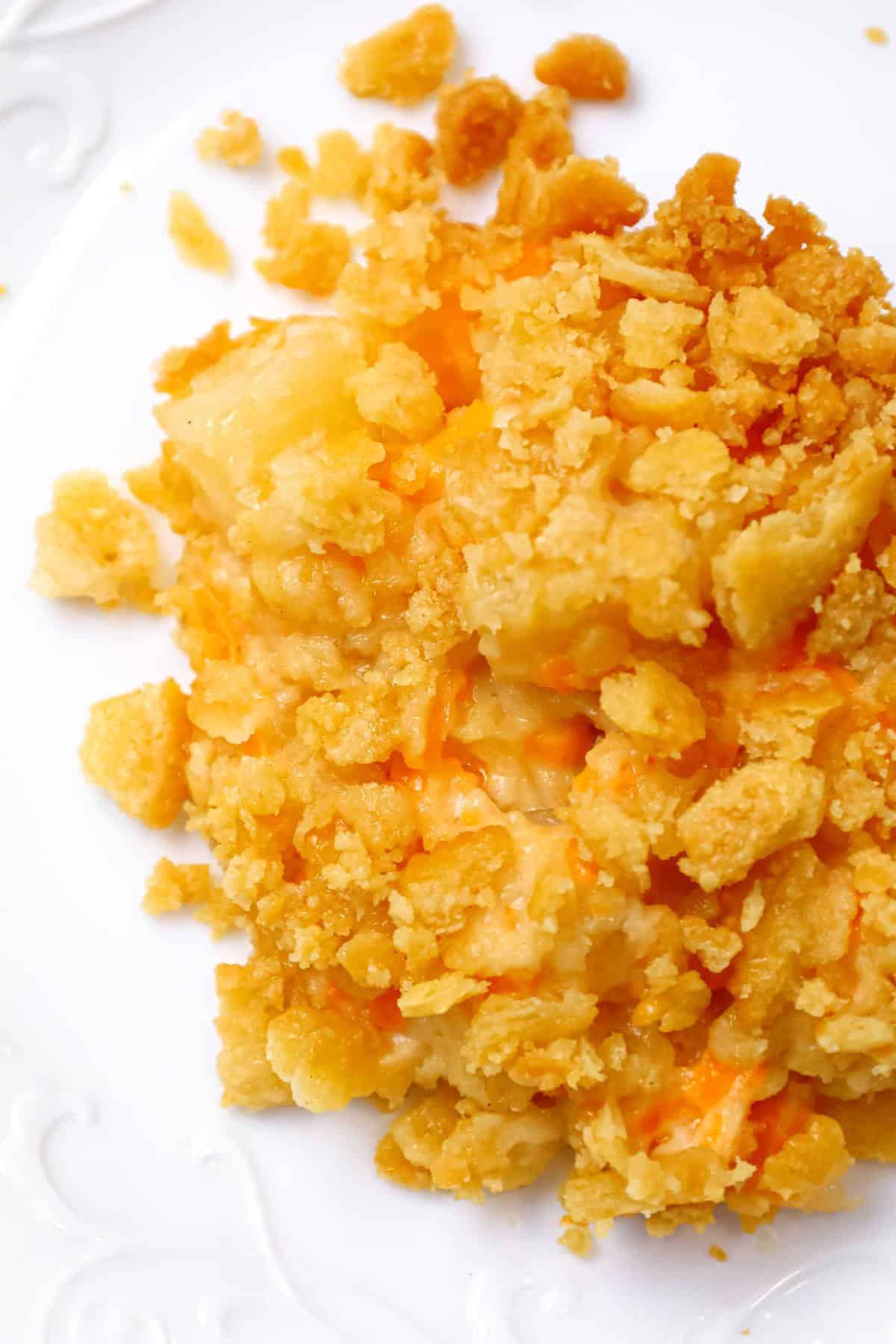 Pineapple Casserole is a sweet and savoury side dish recipe loaded with pineapple chunks, cheddar cheese and Ritz cracker crumbs.