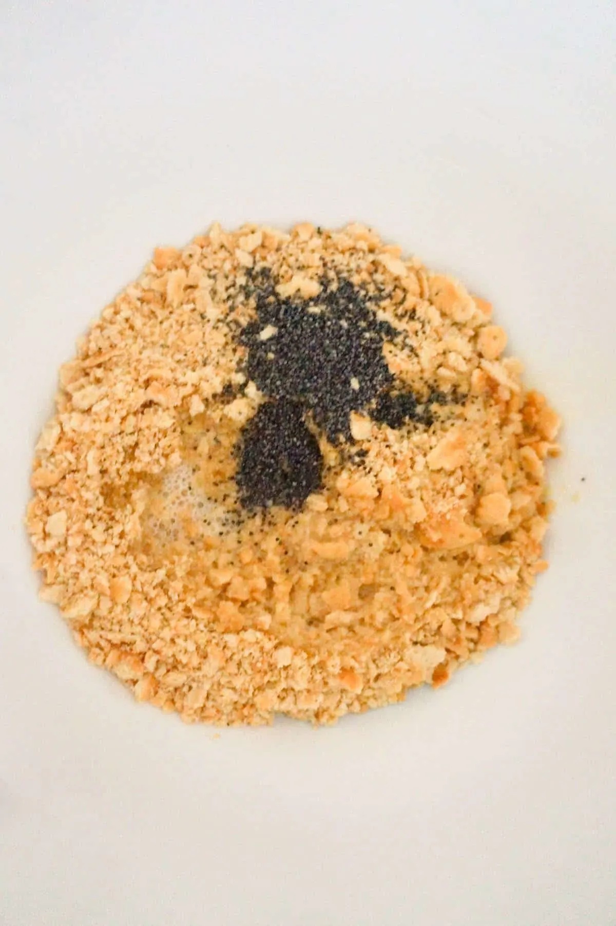poppy seeds, melted butter and Ritz cracker crumbs in a mixing bowl