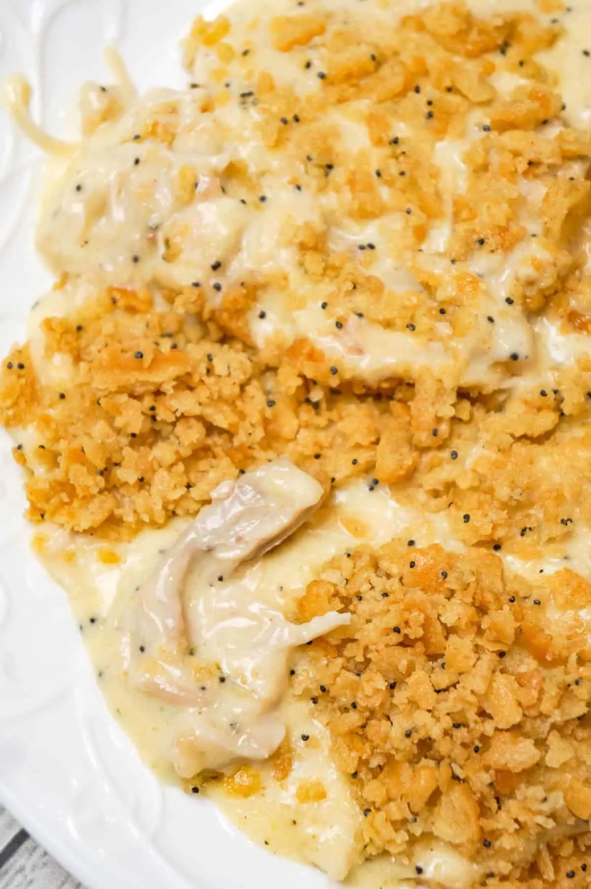 Poppy Seed Chicken Casserole is an easy dinner recipe loaded with shredded chicken, cream of chicken soup, shredded cheese and poppy seeds and topped with crumbled Ritz crackers.