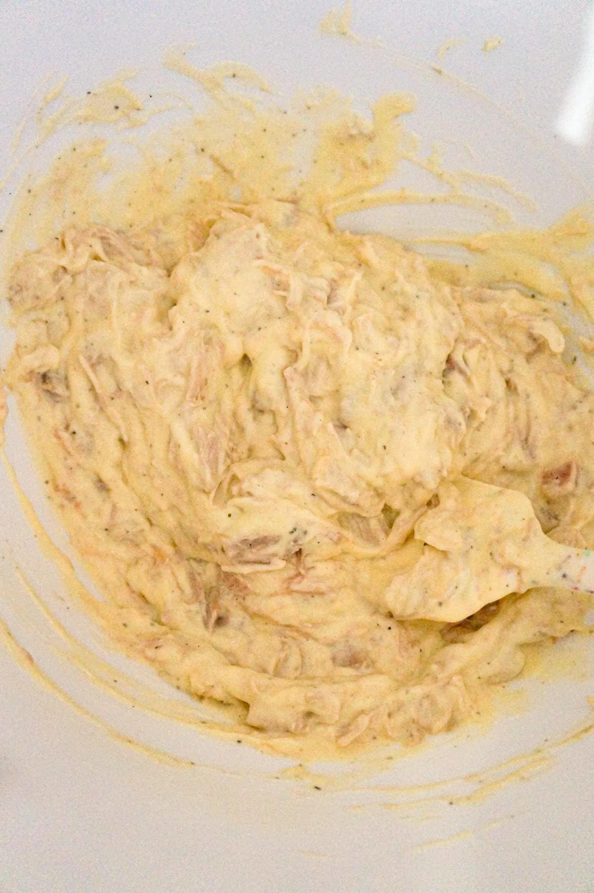cream of chicken soup and shredded chicken mixture in a mixing bowl