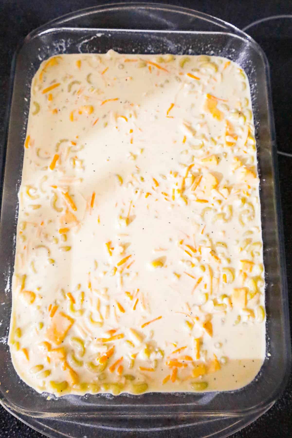creamy macaroni and cheese mixture in a baking dish before cooking