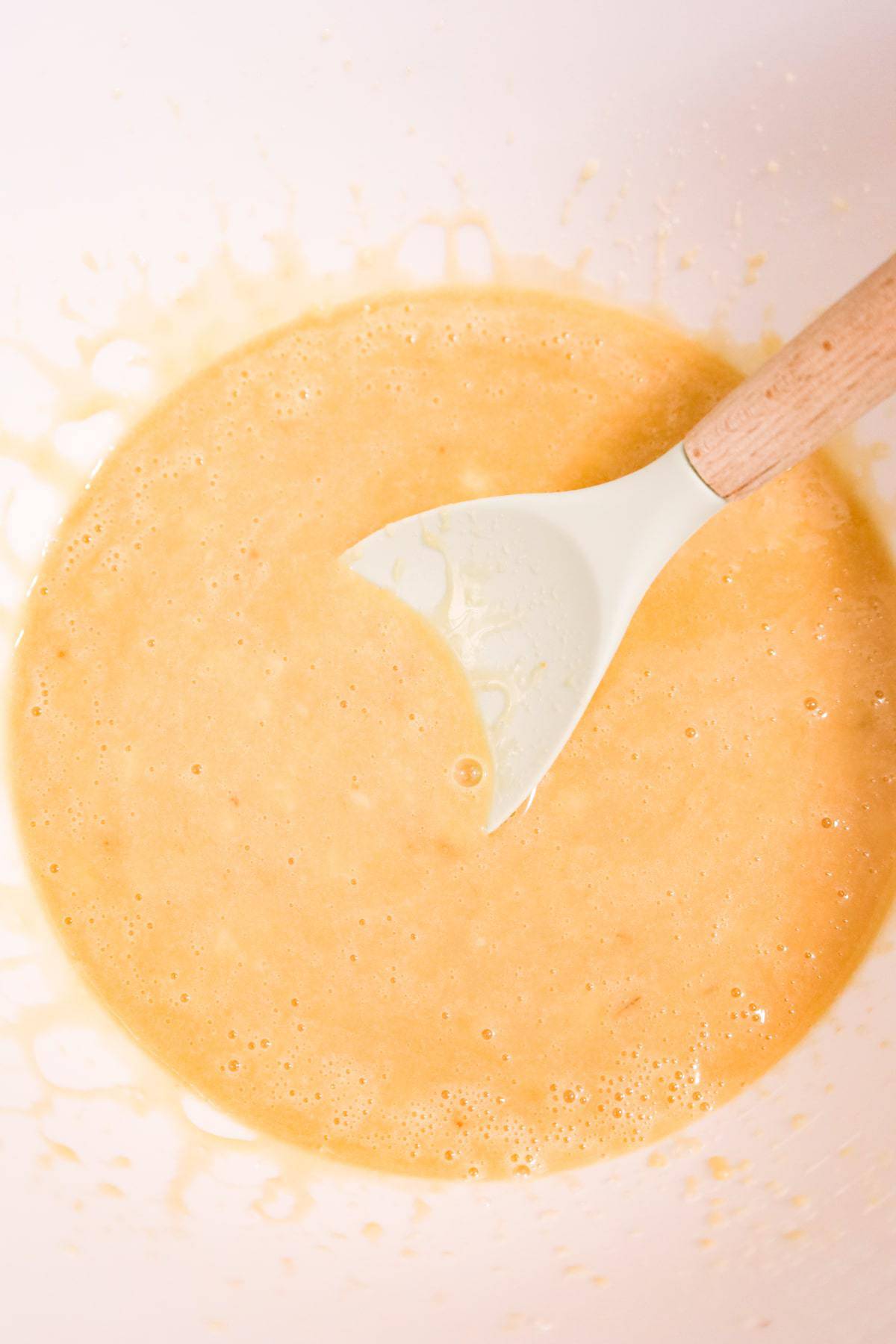 creamy banana, milk and egg mixture in a mixing bowl