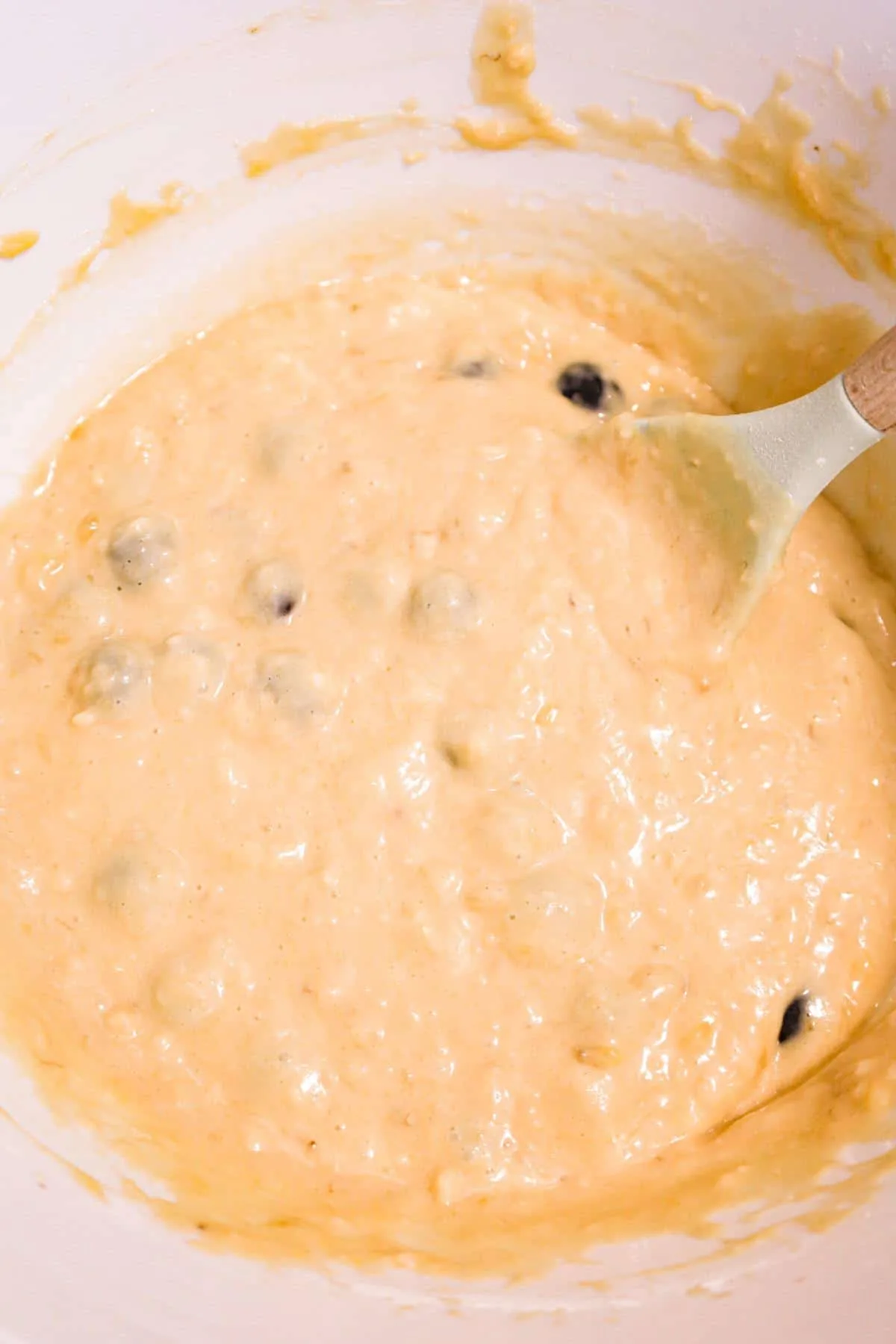 banana blueberry muffin batter in a mixing bowl