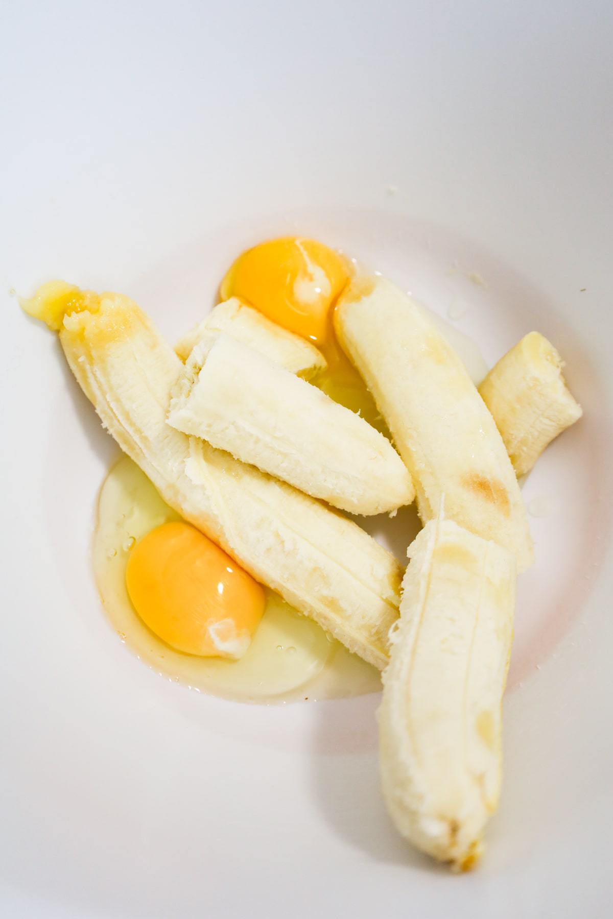 bananas and eggs in a mixing bowl