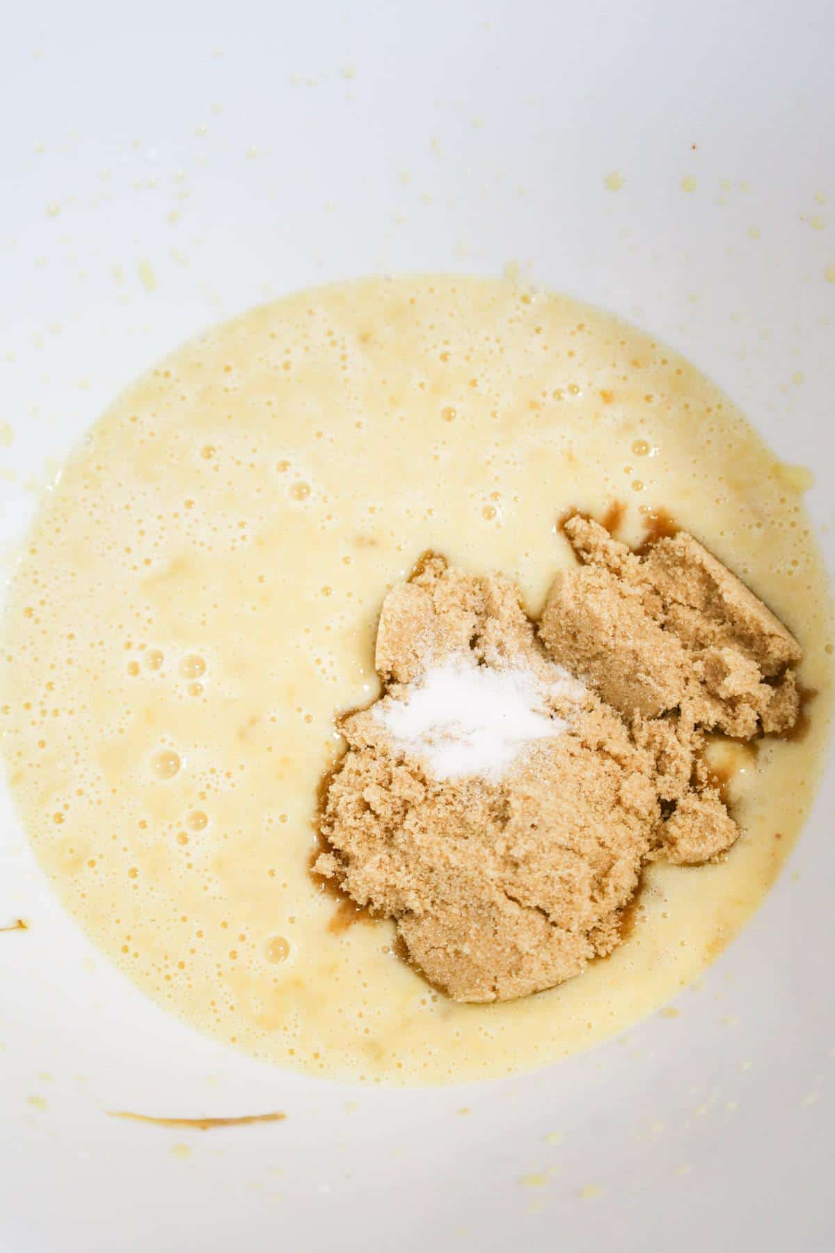 salt and brown sugar on top of creamy banana mixture in a mixing bowl