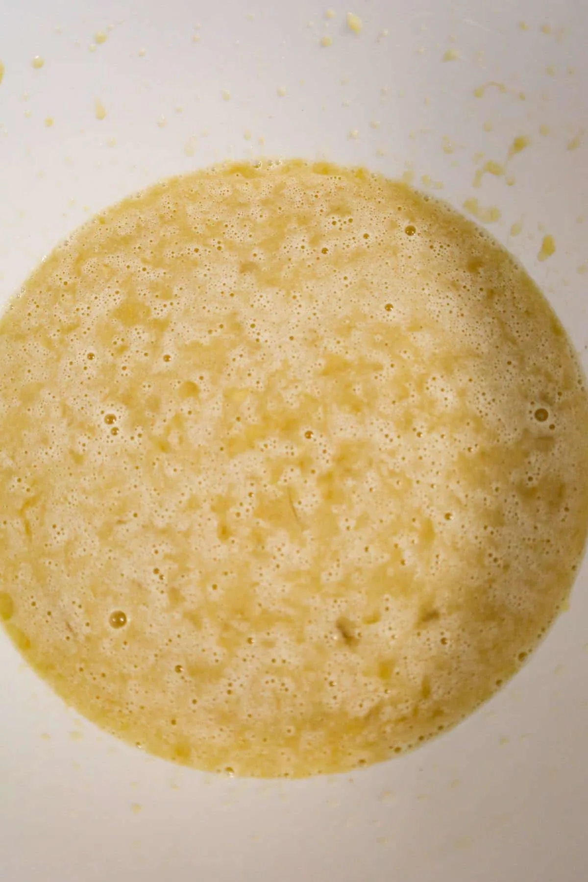 milk, oil, mashed banana and sugar mixture in a mixing bowl