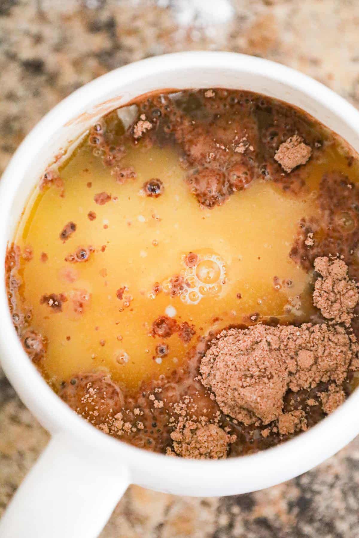 melted butter added to dry brownie mix in a mug