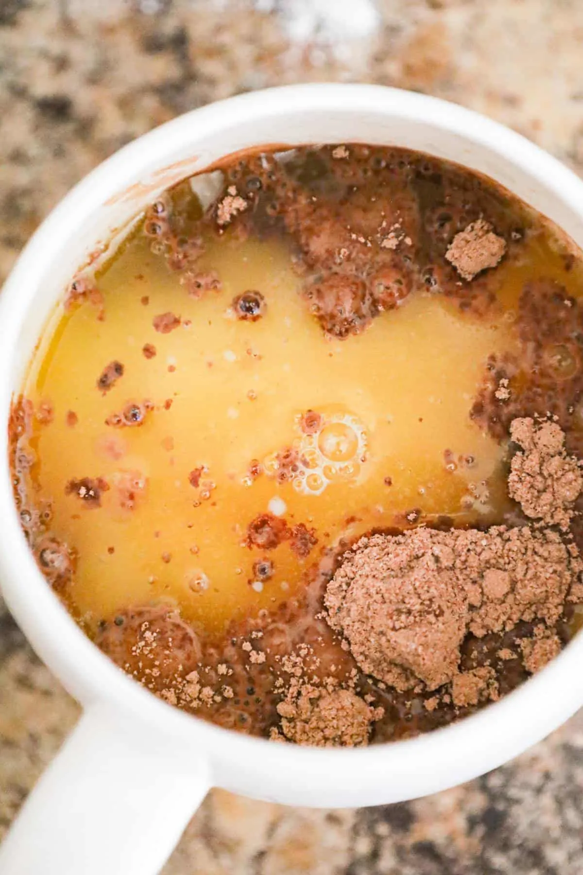 melted butter added to dry brownie mix in a mug