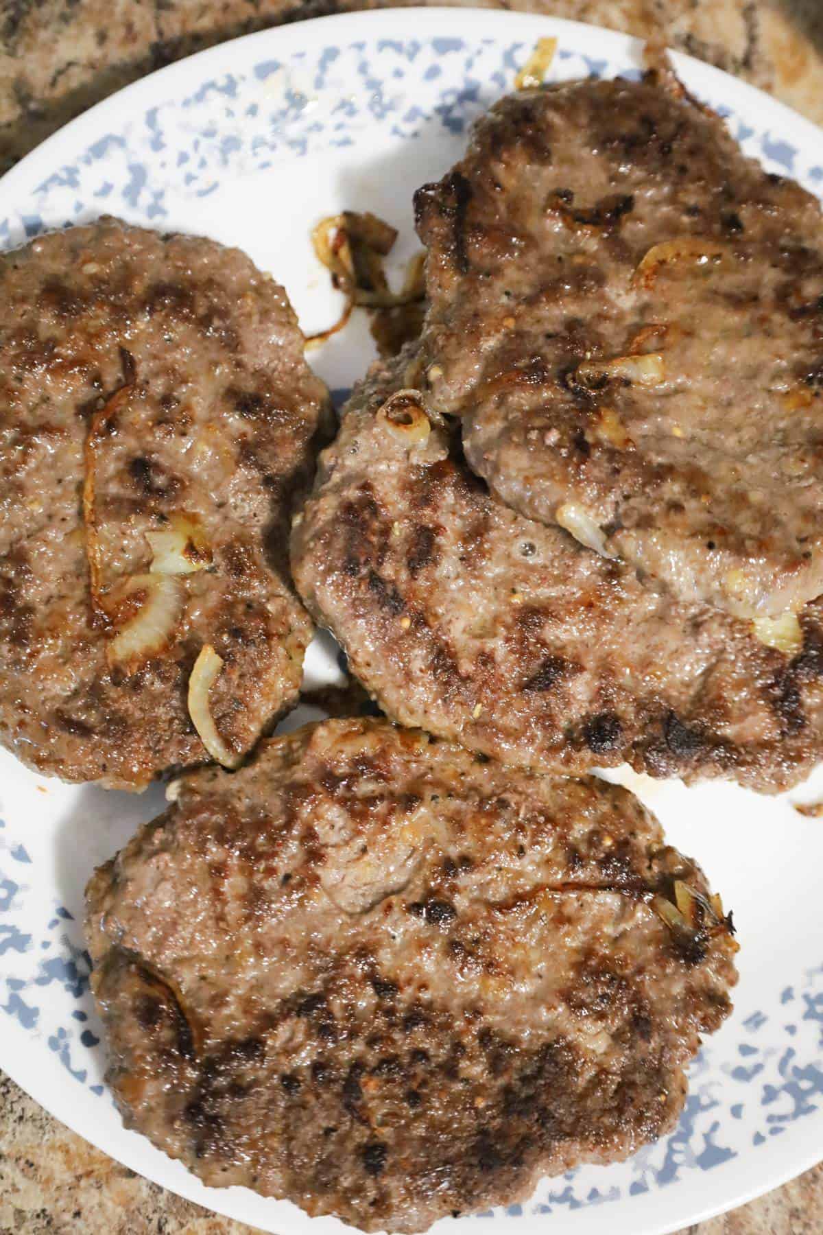 cooked hamburger patties on a plate