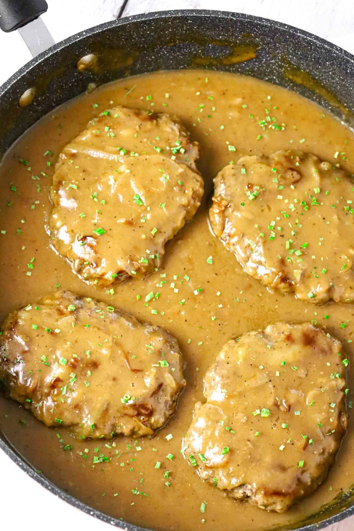 Hamburger Steak is an easy stove top dinner recipe of ground beef patties and onions cooked in brown gravy.