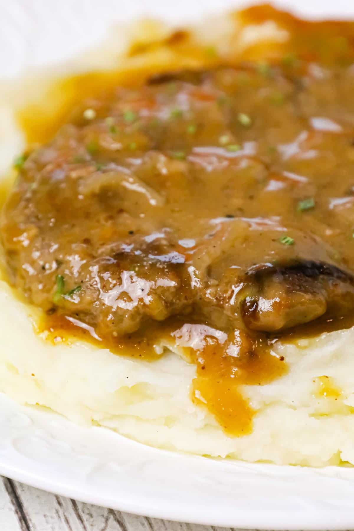 Hamburger Steak is an easy stove top dinner recipe of ground beef patties and onions cooked in brown gravy.