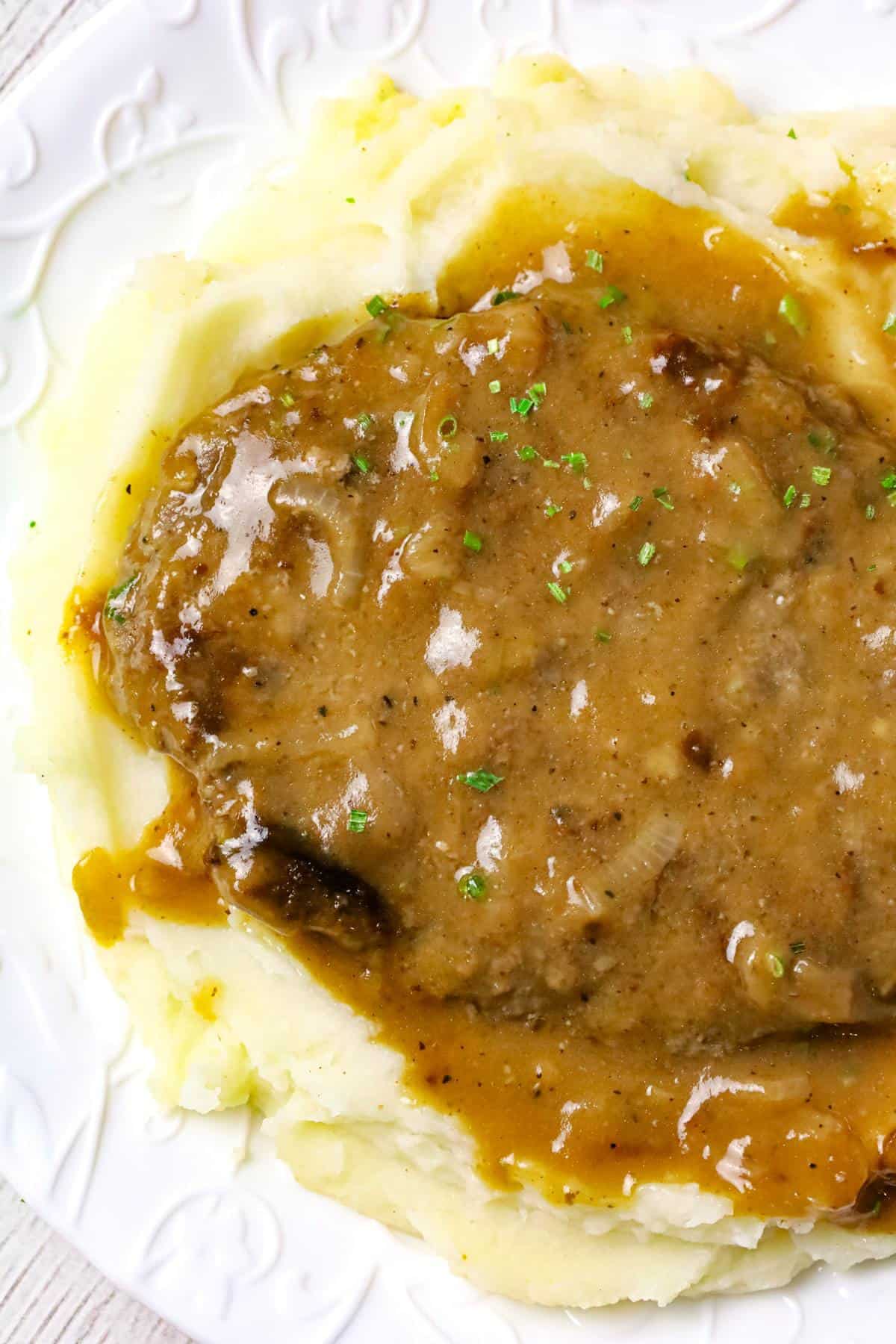 Hamburger Steak is an easy stove top dinner recipe of ground beef patties and onions cooked in brown gravy.