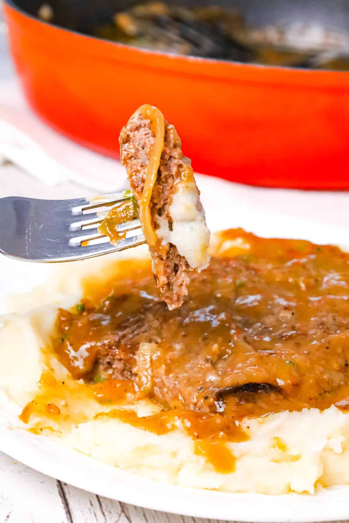 Hamburger Steak is an easy stove top dinner recipe of ground beef patties and onions cooked in brown gravy.