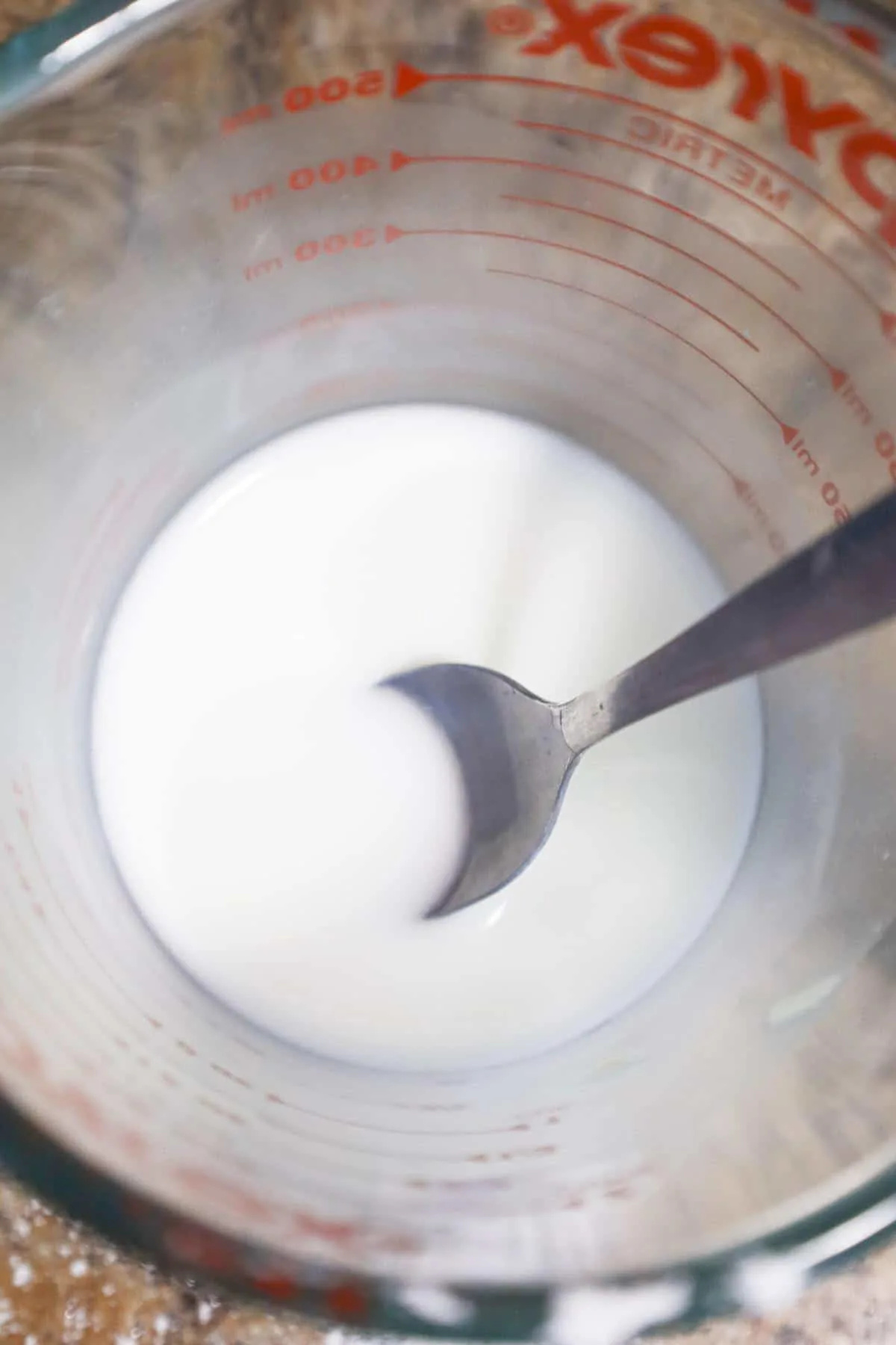 cornstarch and water mixture in a glass measuring cup