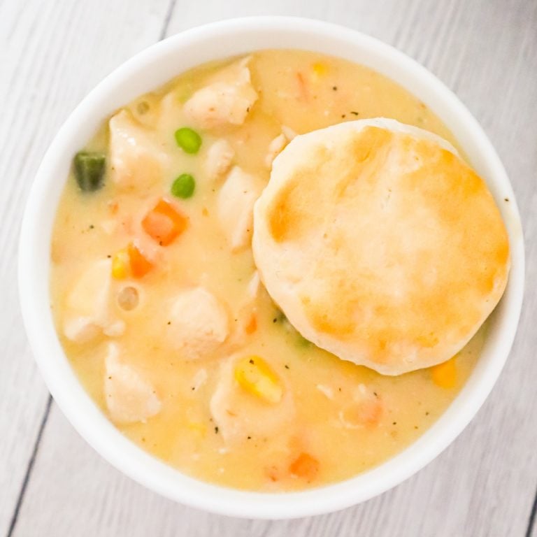 Instant Pot Chicken Pot Pie is a tasty comfort food recipe made with boneless skinless chicken breast chunks and frozen mixed vegetables all in a creamy sauce and served with biscuits instead of in a pie crust.