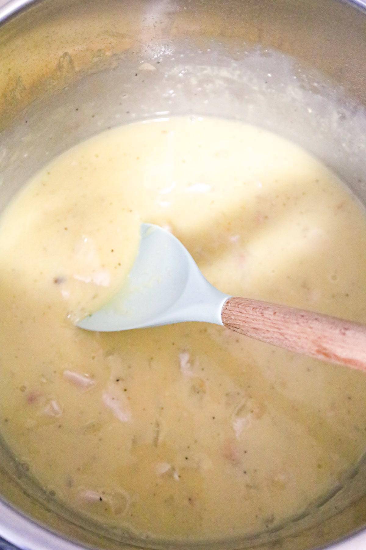 creamy chicken mixture being stirred in an Instant Pot